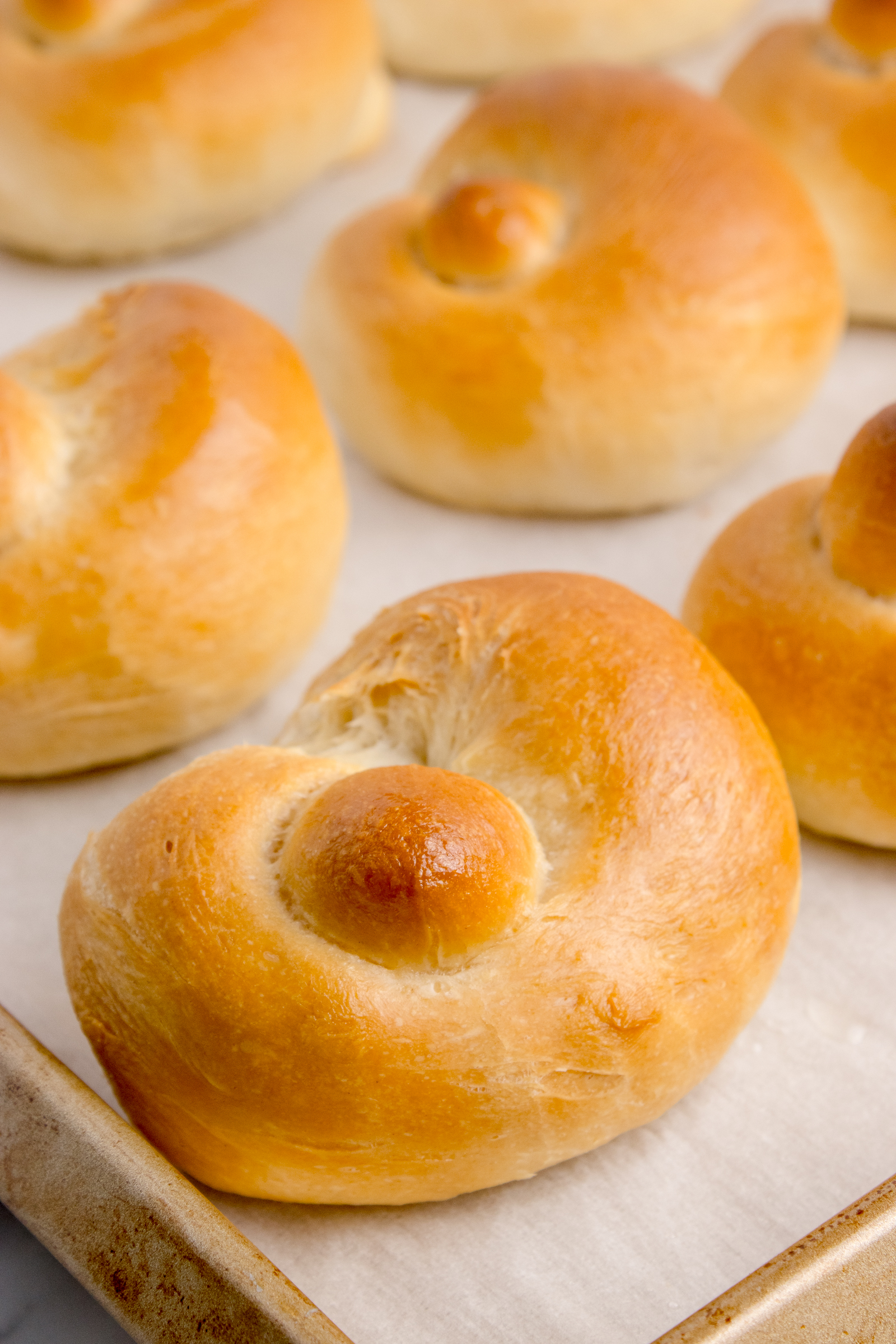 Homemade Garlic Knots on a baking sheet without the topping on them yet 
