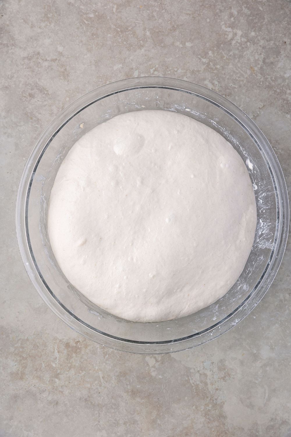 Homemade Sourdough Bread dough risen in a glass bowl 
