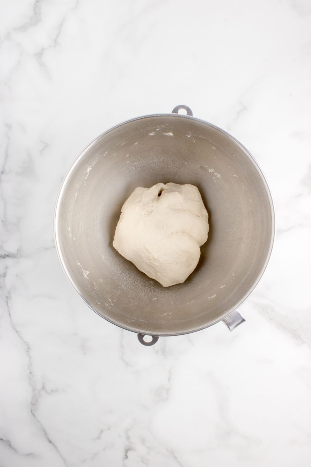 roll dough in a metal bowl on table 