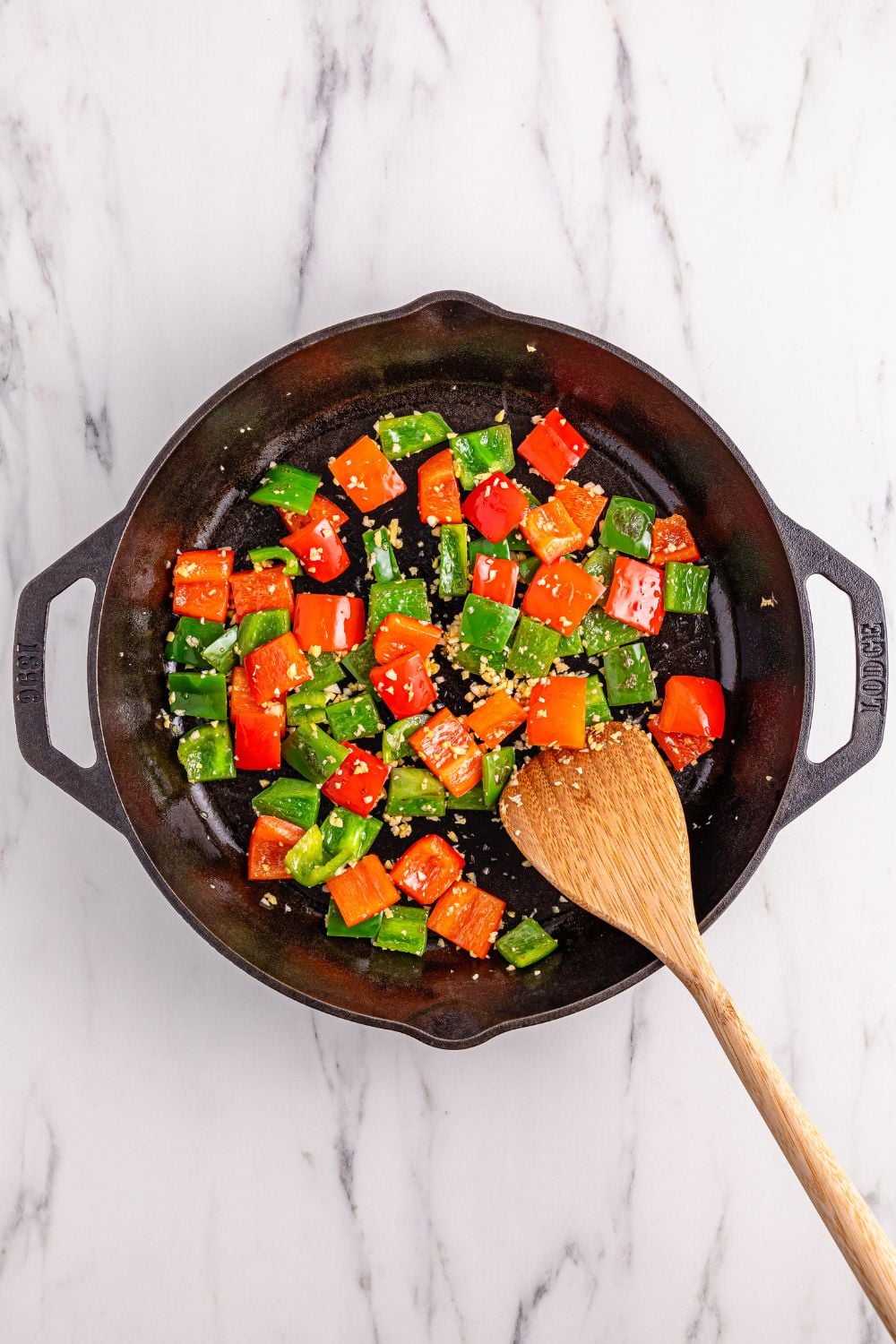 cast iron skillet with sauted vegetables for Better Than Takeout Kung Pao Chicken
