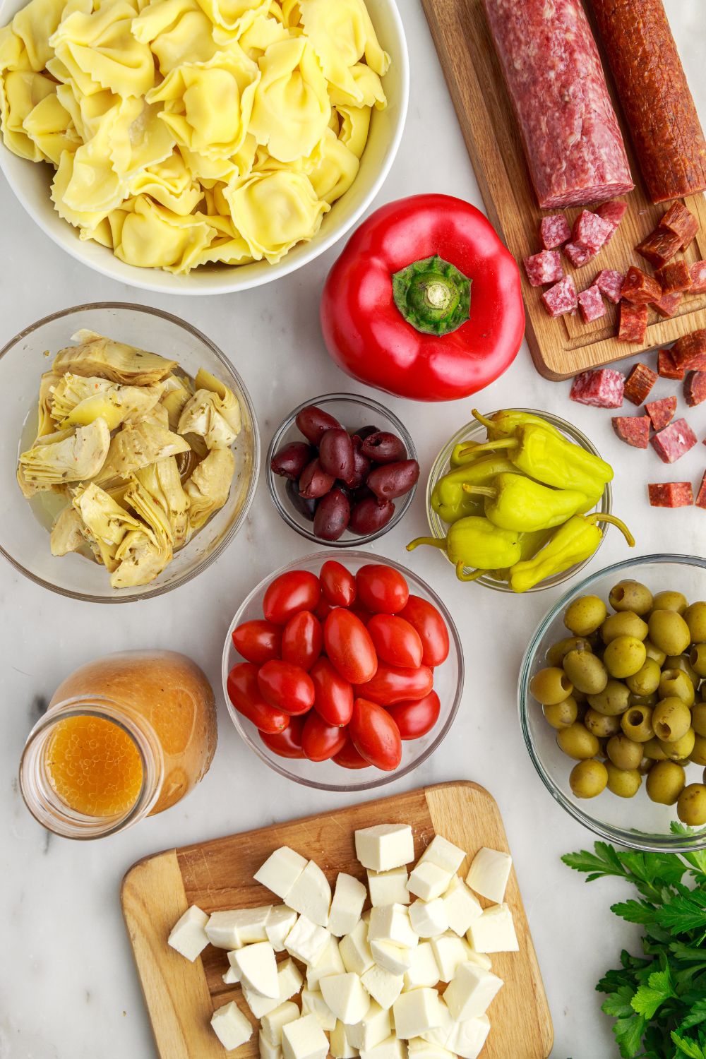 ingredients for Antipasto Tortellini Pasta Salad spread out on table 
