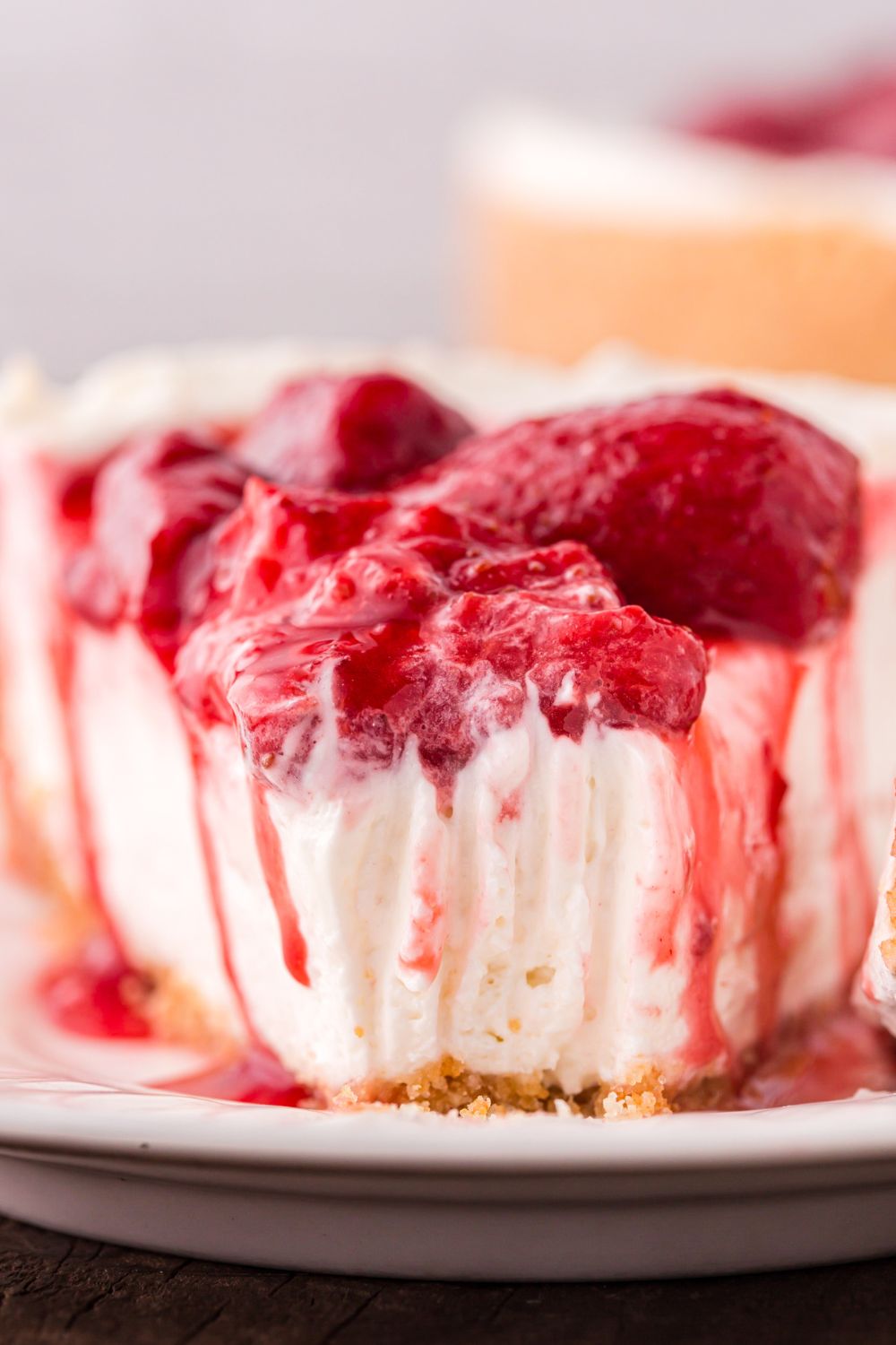 No Bake Strawberry Cheesecake sliced on a plate with a bite taken out of it