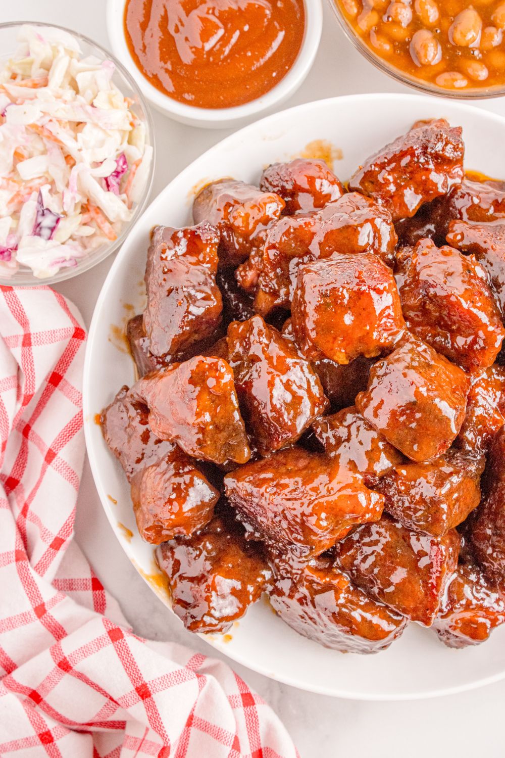 Chuck Roast Burnt Ends on a plate on table with a towel to the side