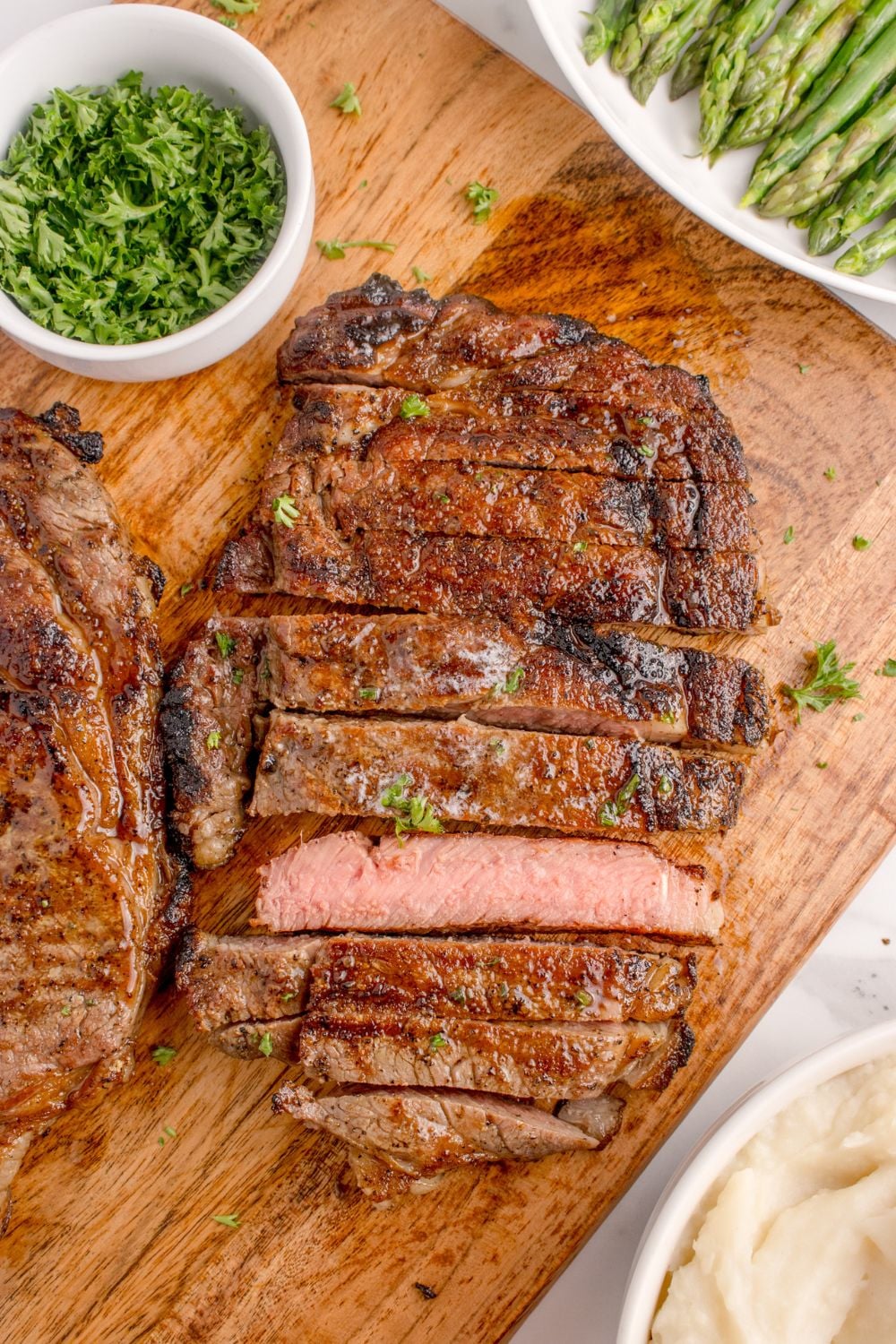 Grilled Ribeye Steaks sliced into strips showing a medium rare steak