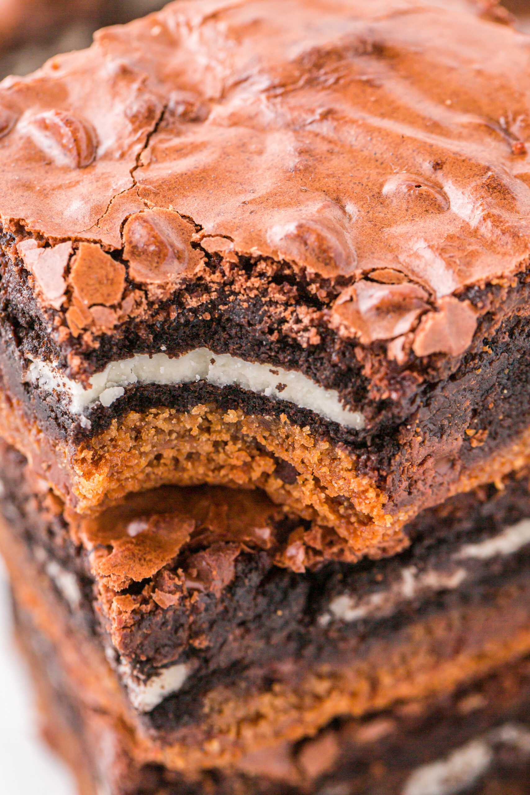 up close shot of the layered Slutty Brownies with a bite missing 