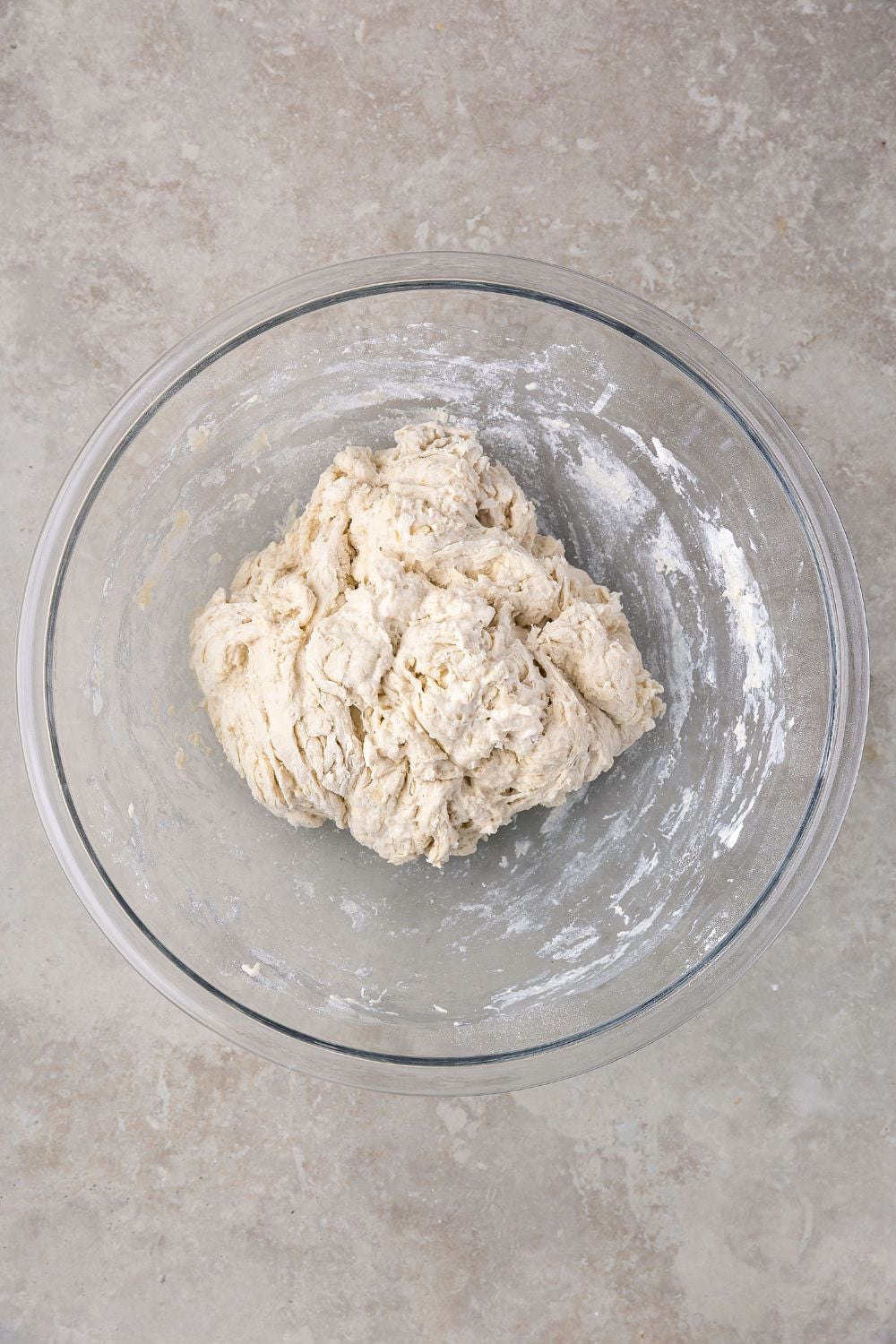 rough mixed dough for Homemade Sourdough Bread on table 