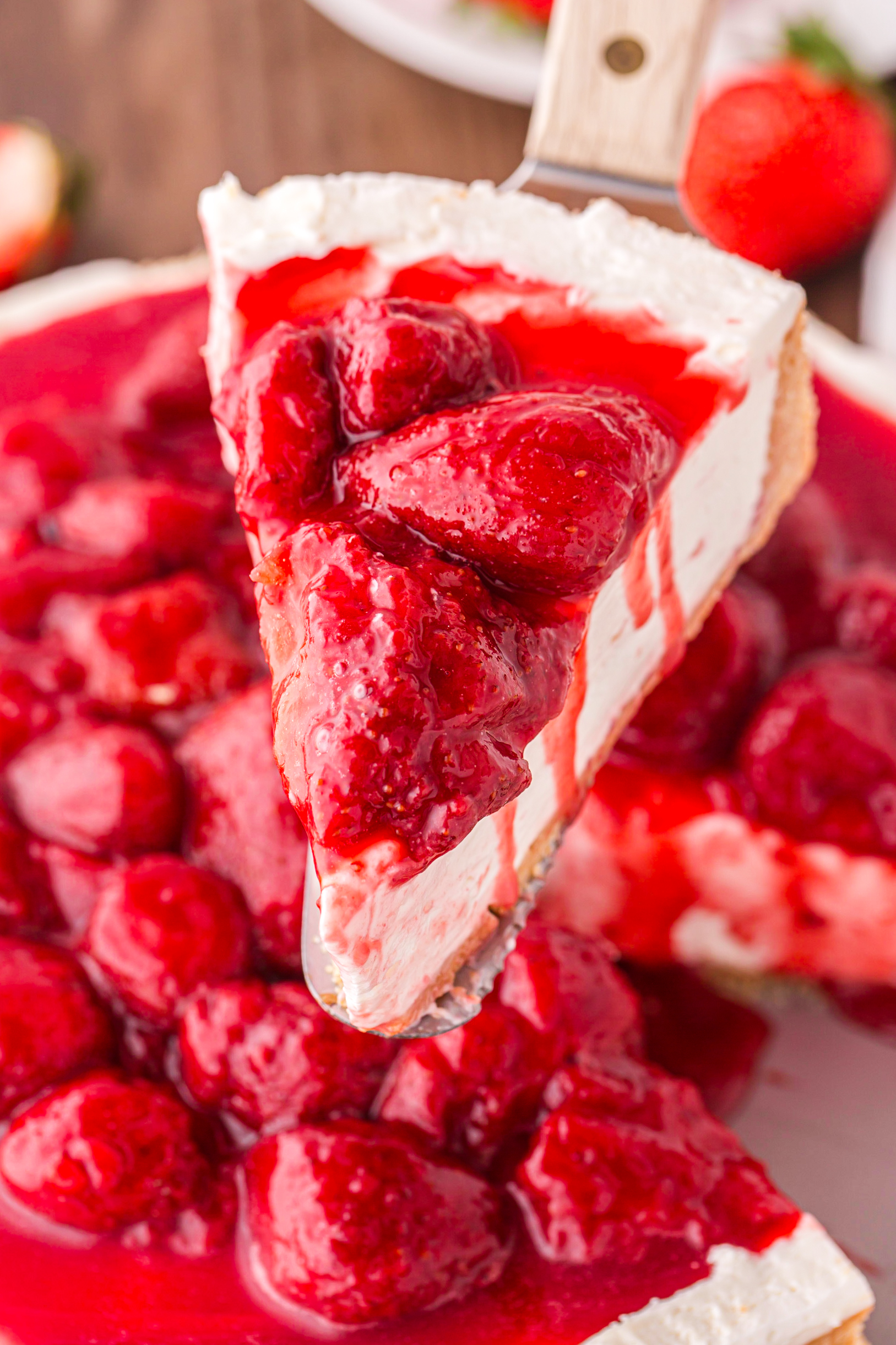 slice of No Bake Strawberry Cheesecake being lifted up