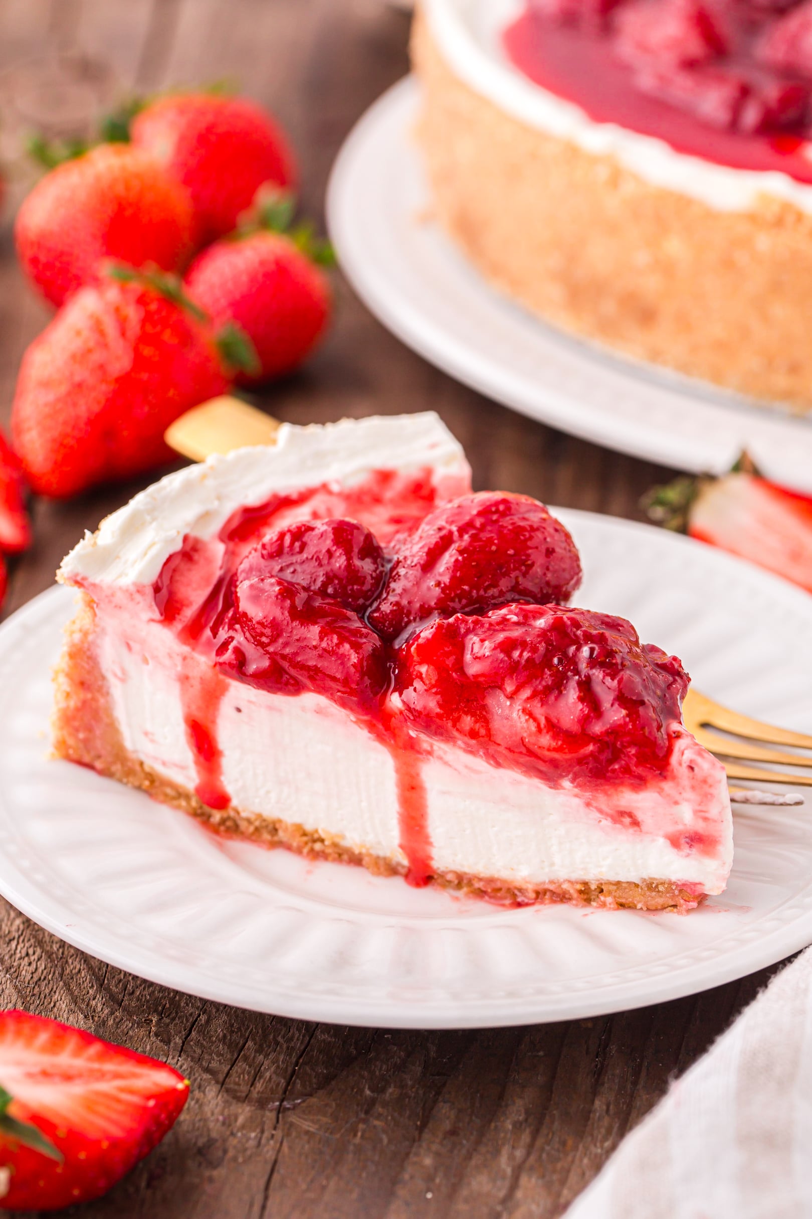 big slice of the No Bake Strawberry Cheesecake on a white plate