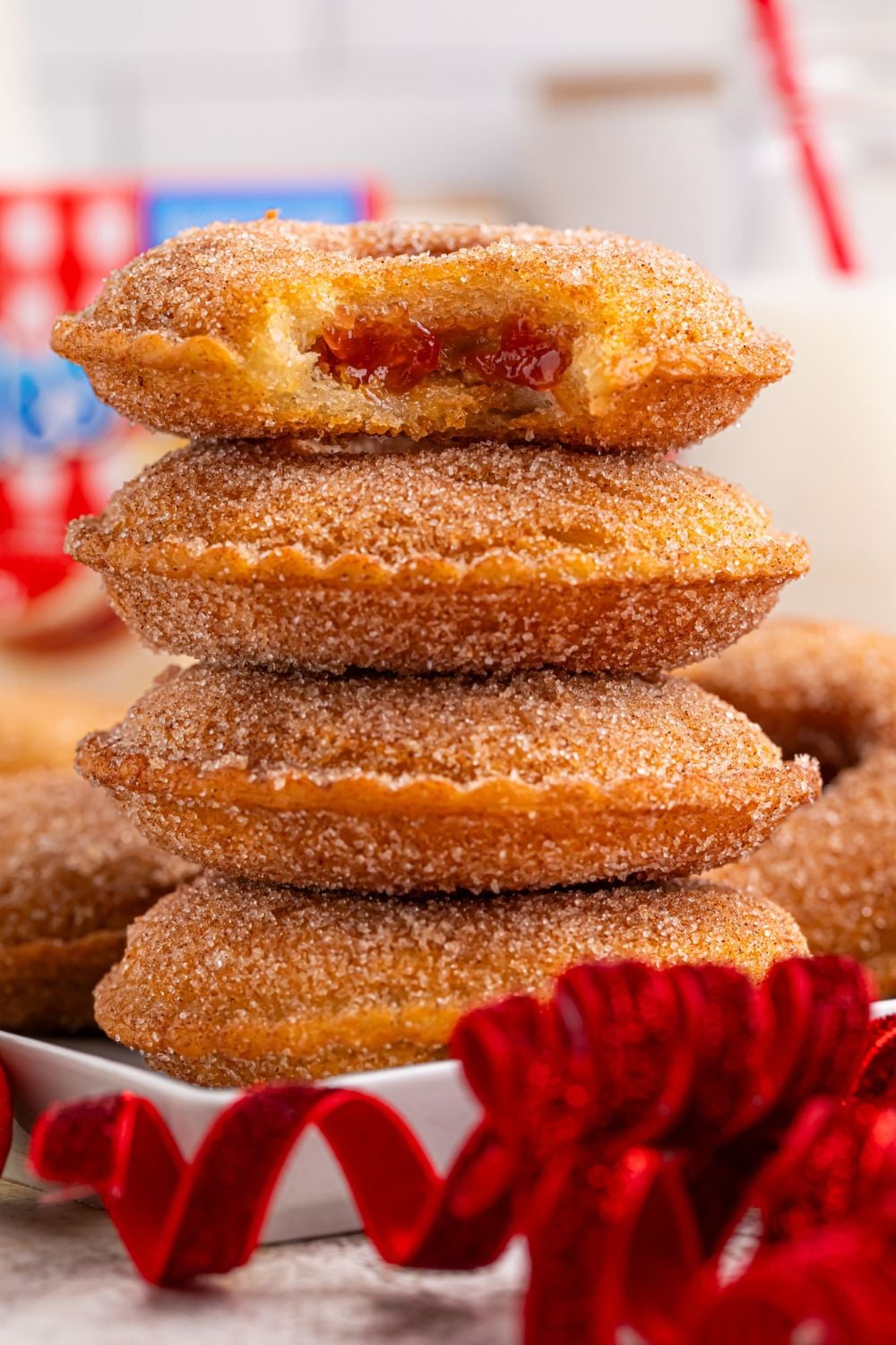 Fried Uncrustables stacked on a plate with top one that has a bite taken out of it 