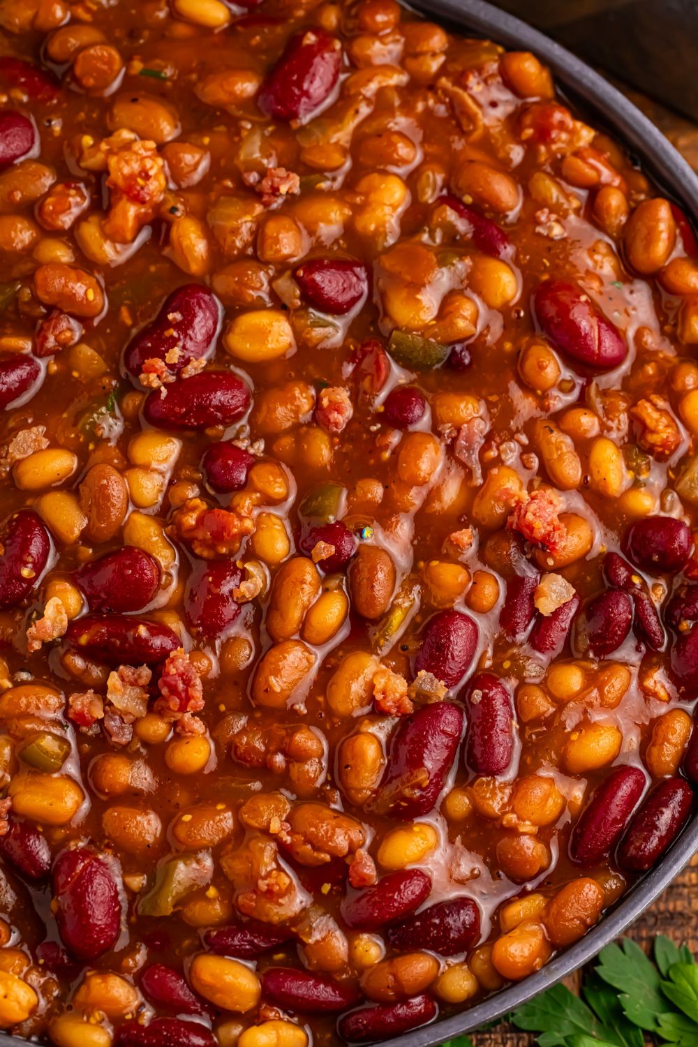 Crockpot bourbon baked beans close up in a bowl to see all the colors of beans