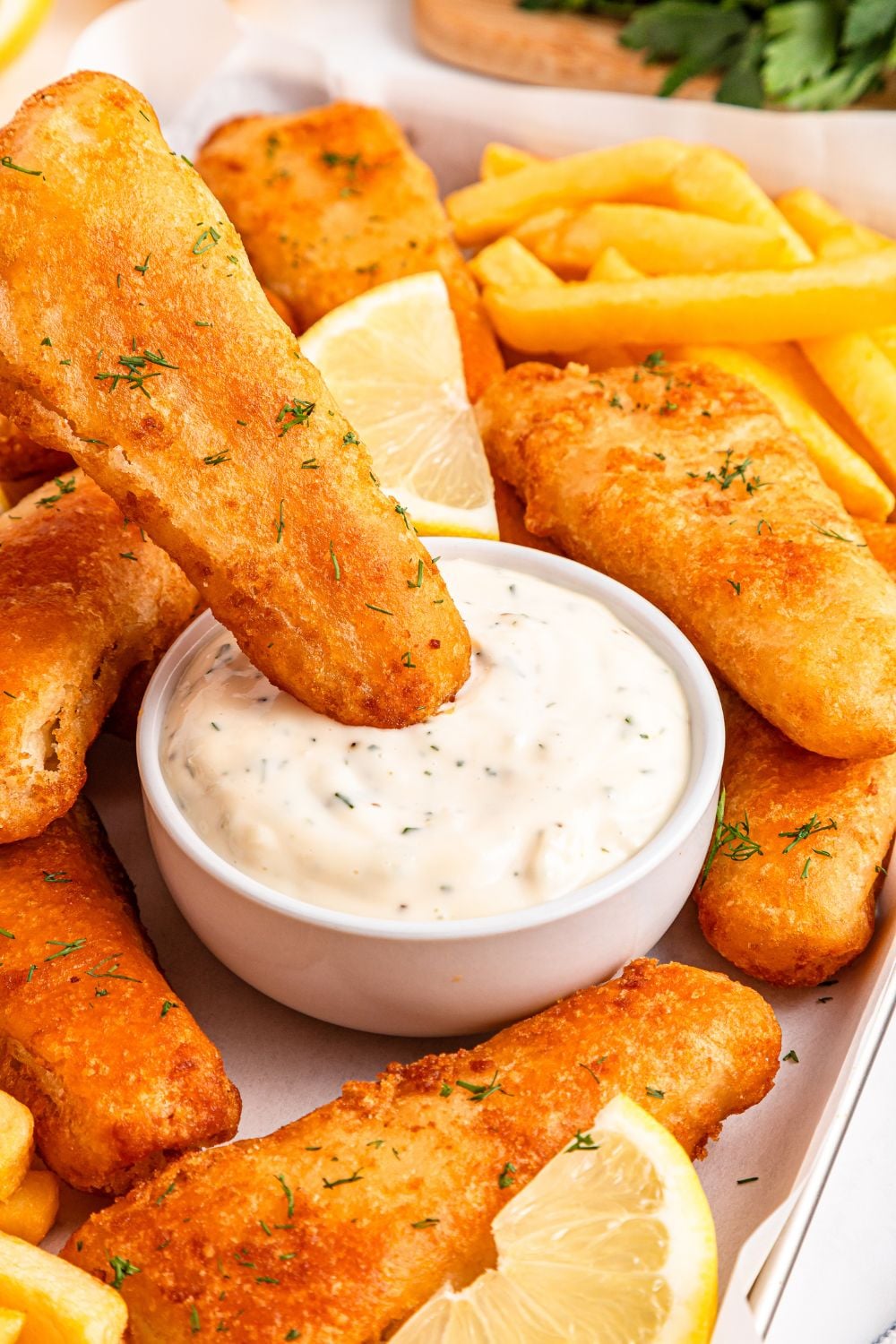Easy Homemade Tarter Sauce in a bowl with a fish fillet dipping in bowl