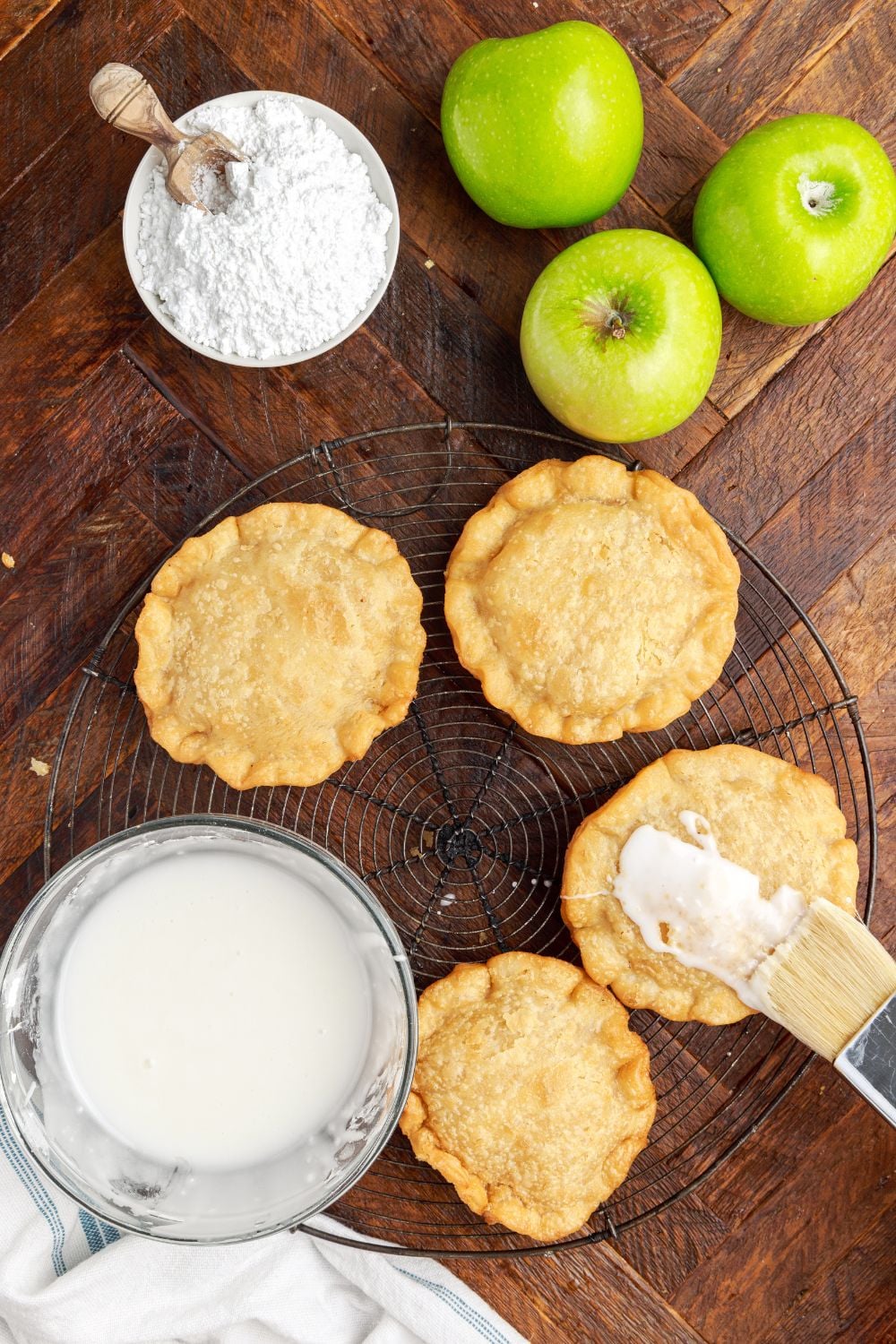 glaze brushed on top of each handpie with apples