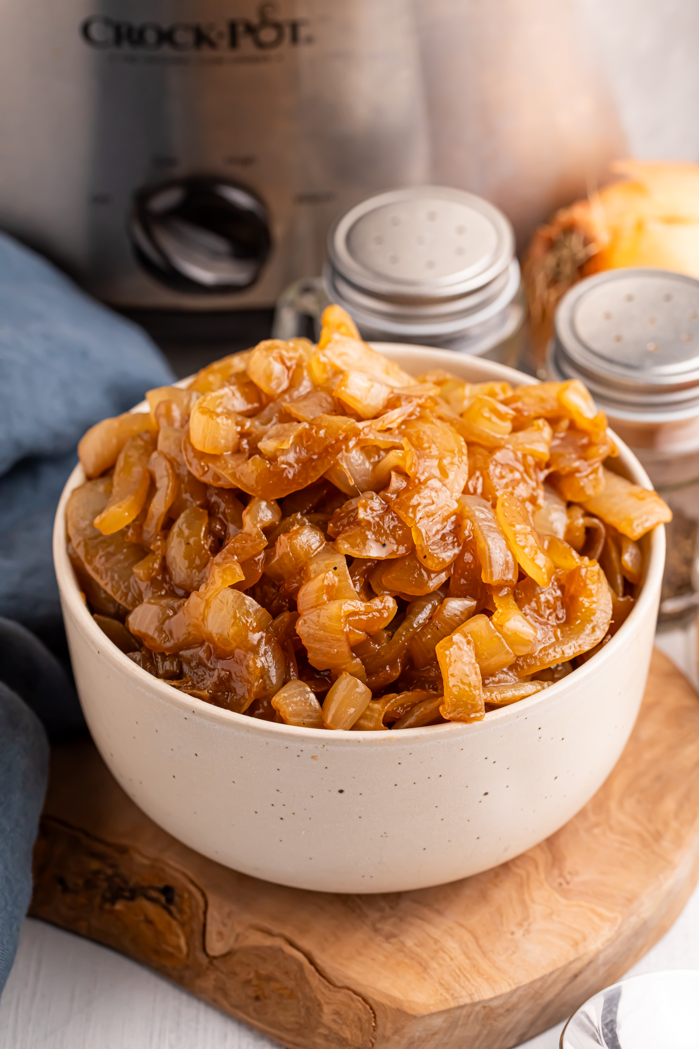 close up of a white bowl filled with the CrockPot Caramelized Onions