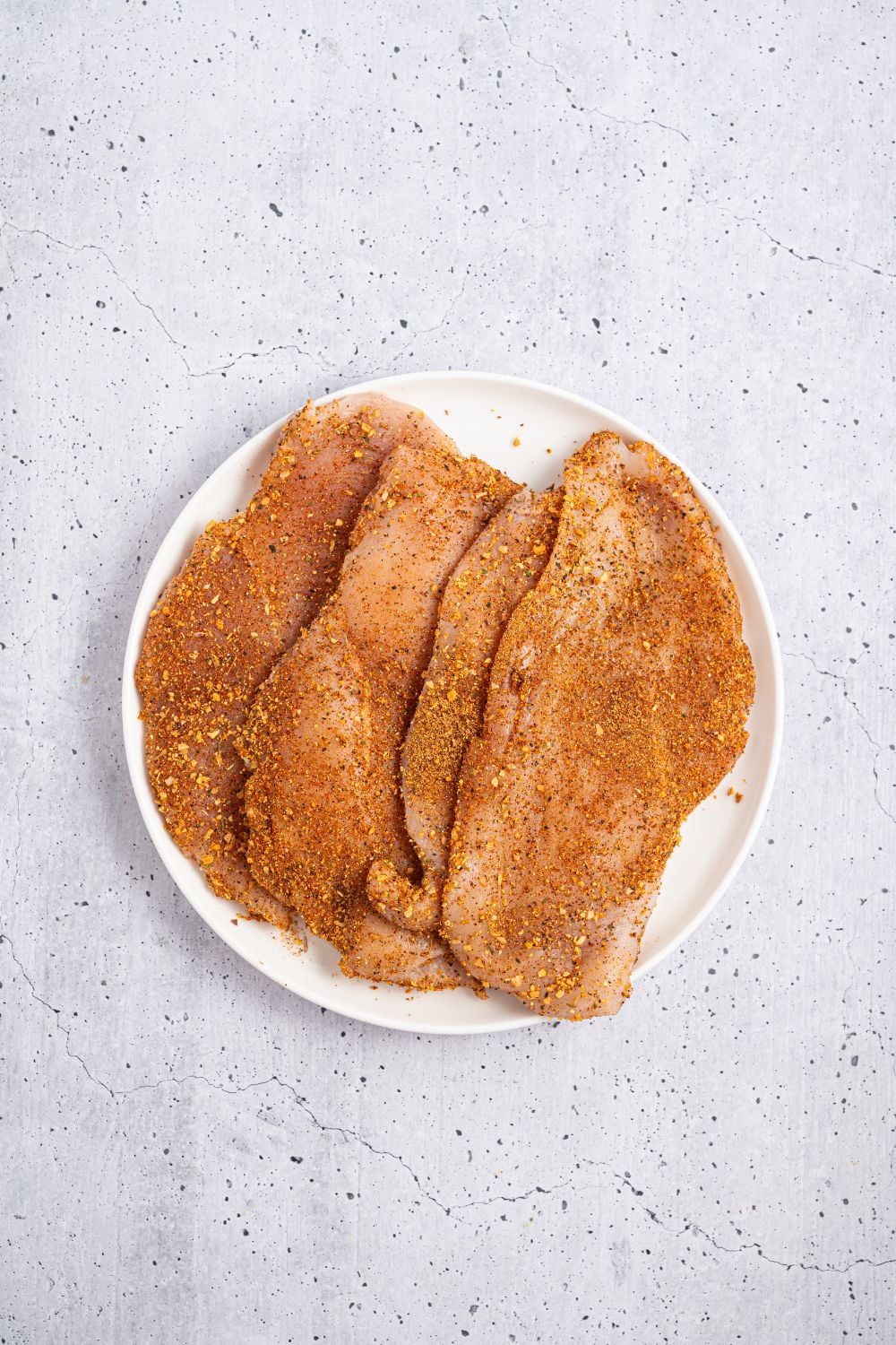 seasoned raw chicken on a plate