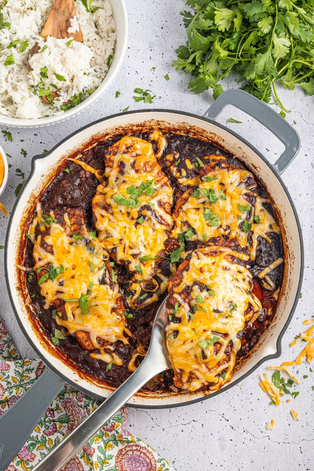 Cheesy Salsa Chicken on pan with a spatula being lifted out of pan 