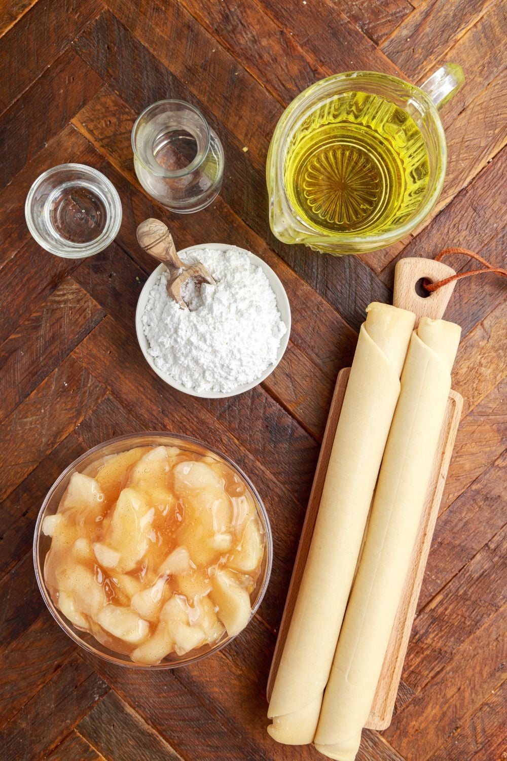 ingredients for Deep Fried Apple Hand Pies in single serve containers on table