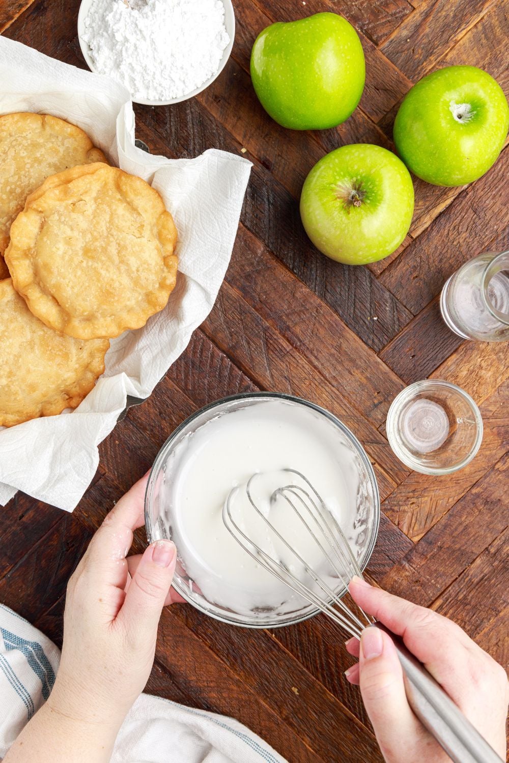 Deep Fried Apple Hand Pies whisked in a bowl with apples to side