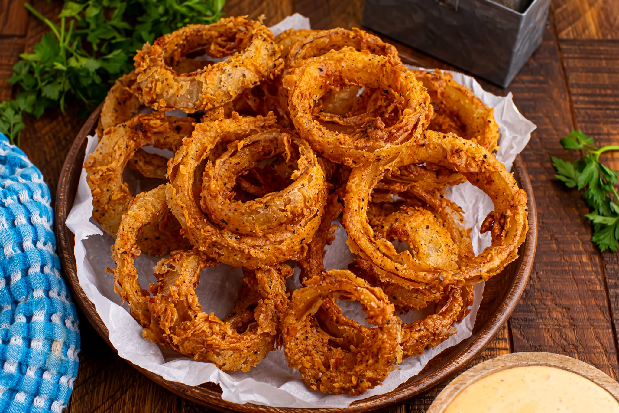 deep friend onion rings on a dark wood table