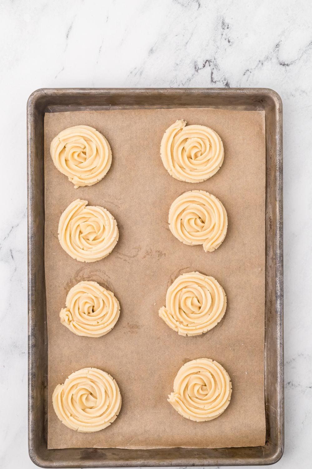 raw shaped Butter Cookies on a cooling rack