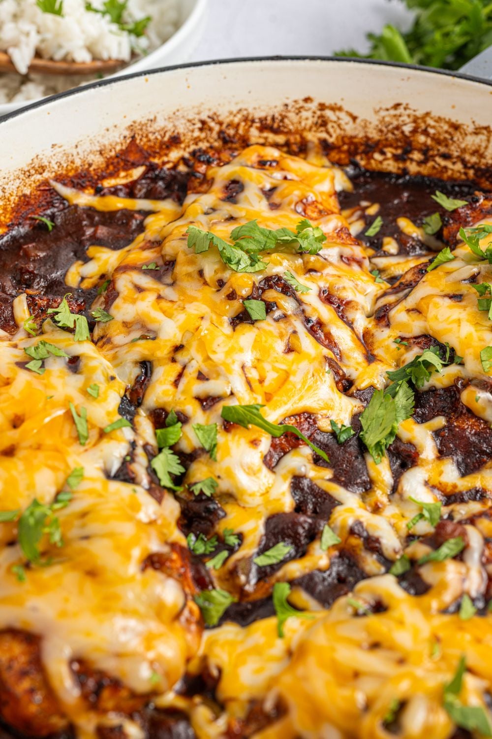 Cheesy Salsa Chicken in a skillet on table with parsley 