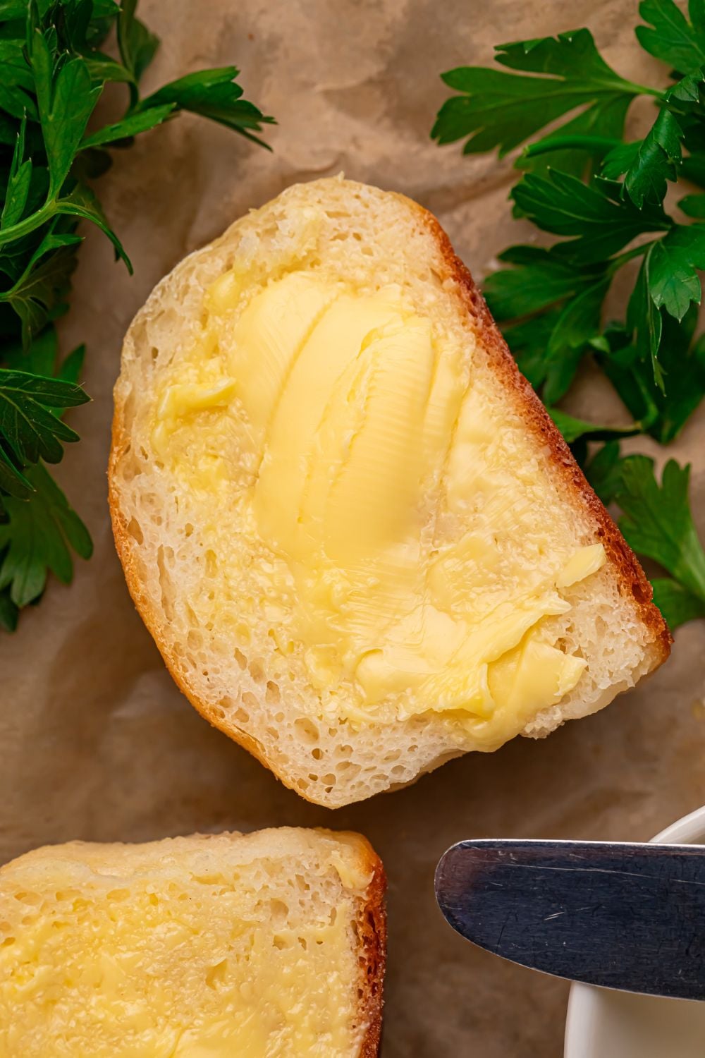 2 Ingredient Dinner Rolls sliced in half spread with butter and herbs to side