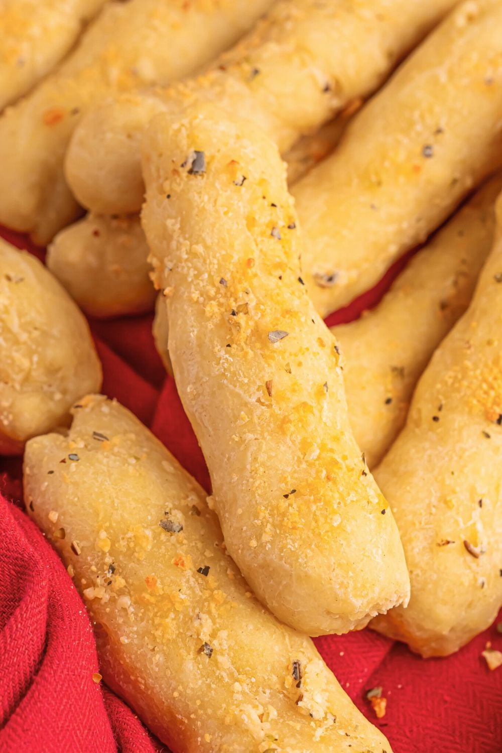 2 Ingredient Garlic Parmesan Breadsticks stacked on top of each other on table