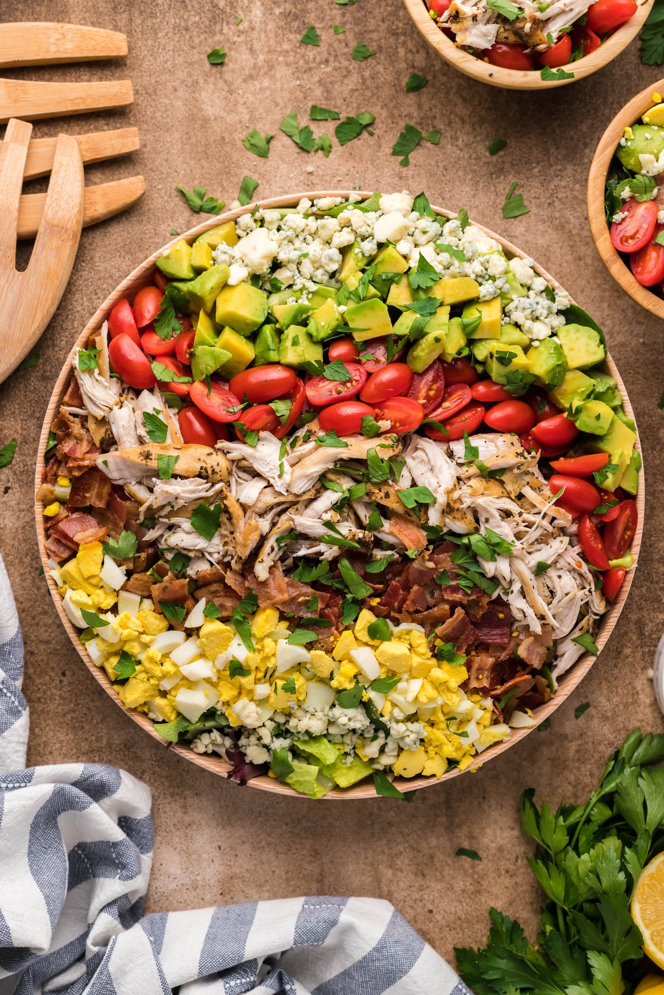 overhead shot of the Copycat Cheesecake Factory Cobb Salad in a large wooden serving bowl on a table 
