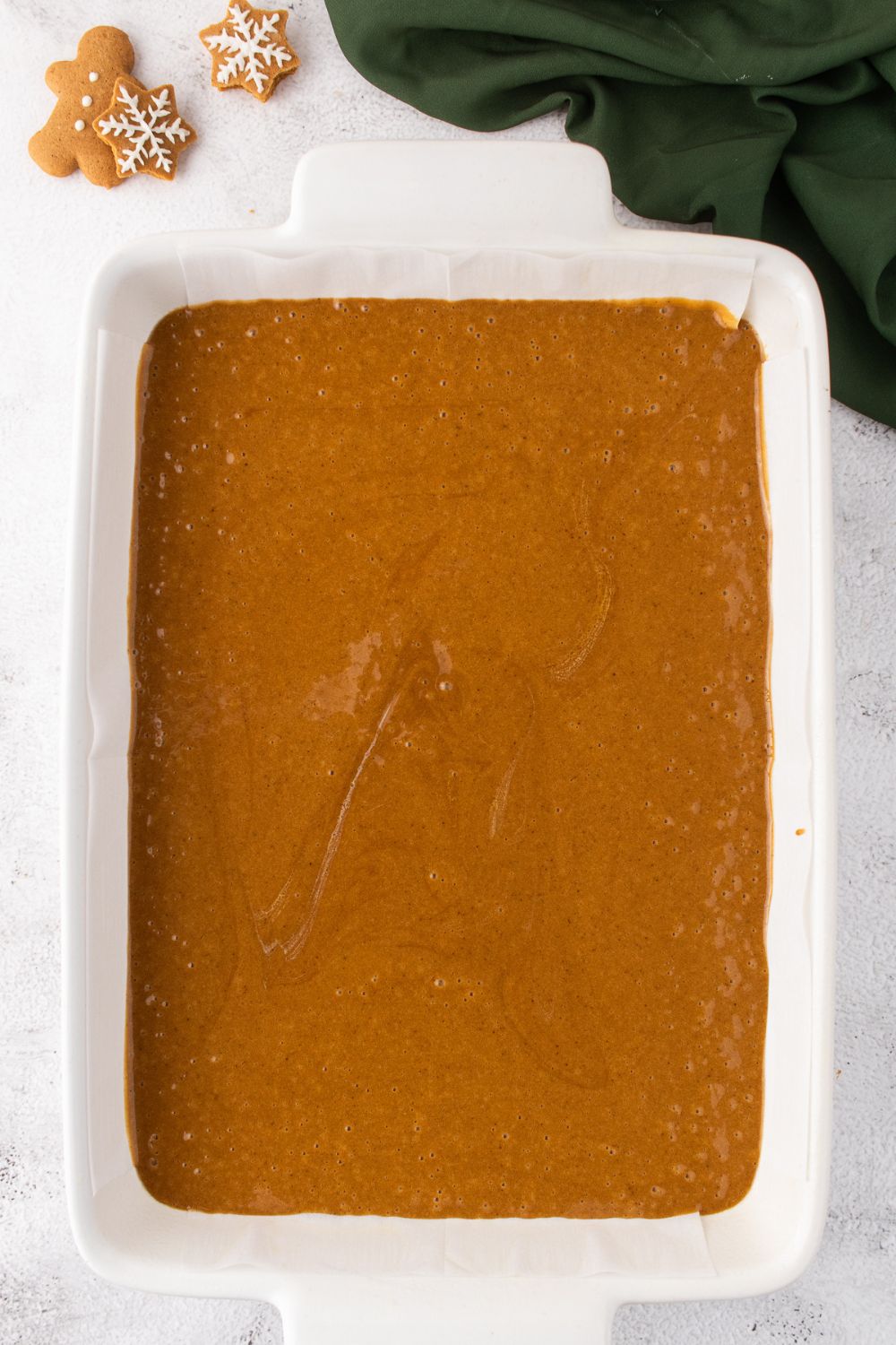 raw gingerbread cake batter in a pan