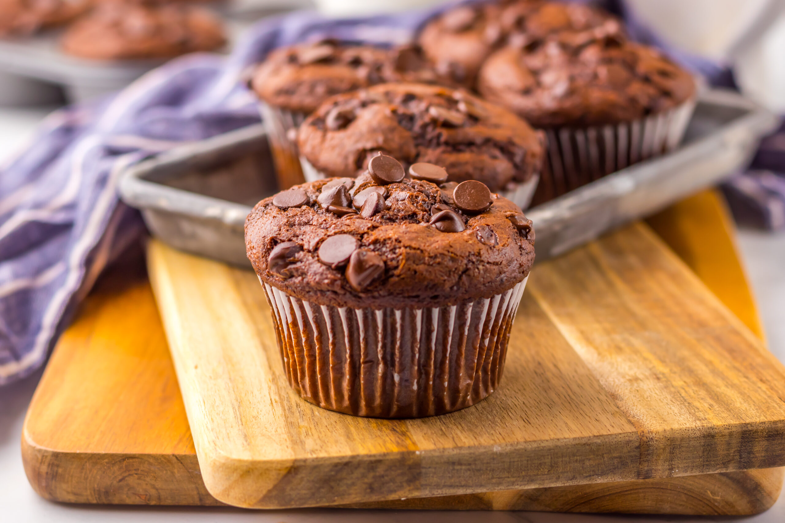 Costco Double Chocolate Muffins on a wooden cutting board up close