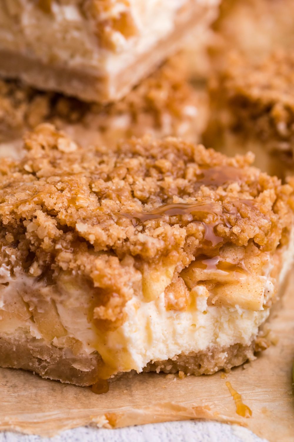 Caramel Apple Cheesecake Bar on table with a bite taken out of it 