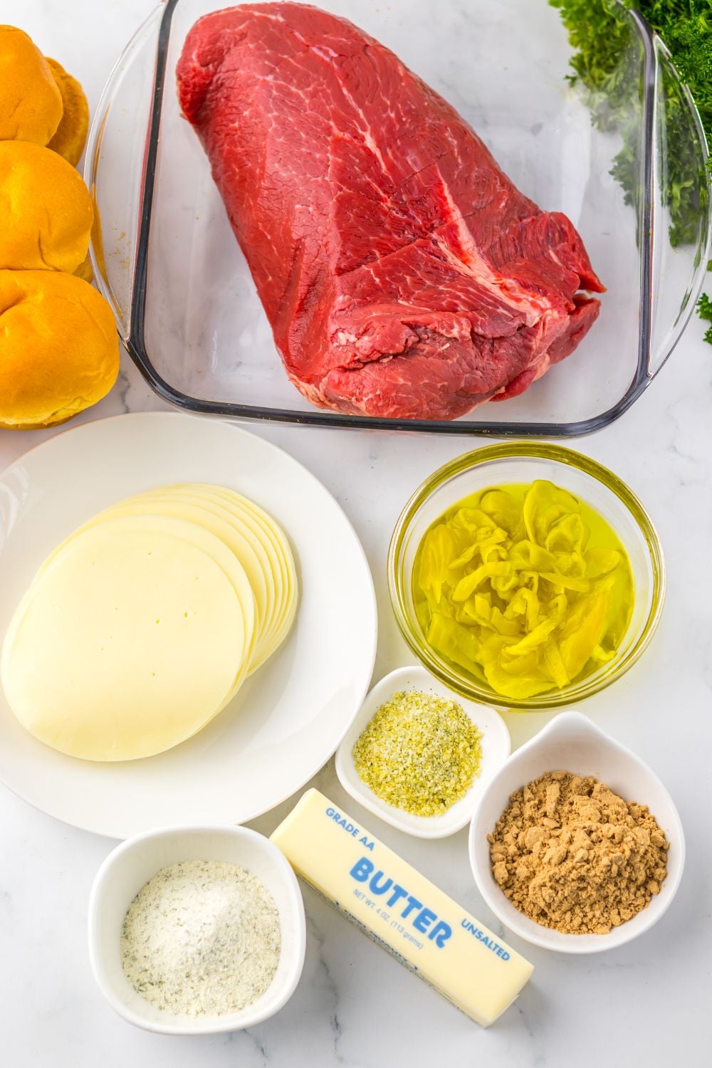 Slow Cooker Mississippi Pot Roast Sliders ingredients all on single serve containers sitting on table 