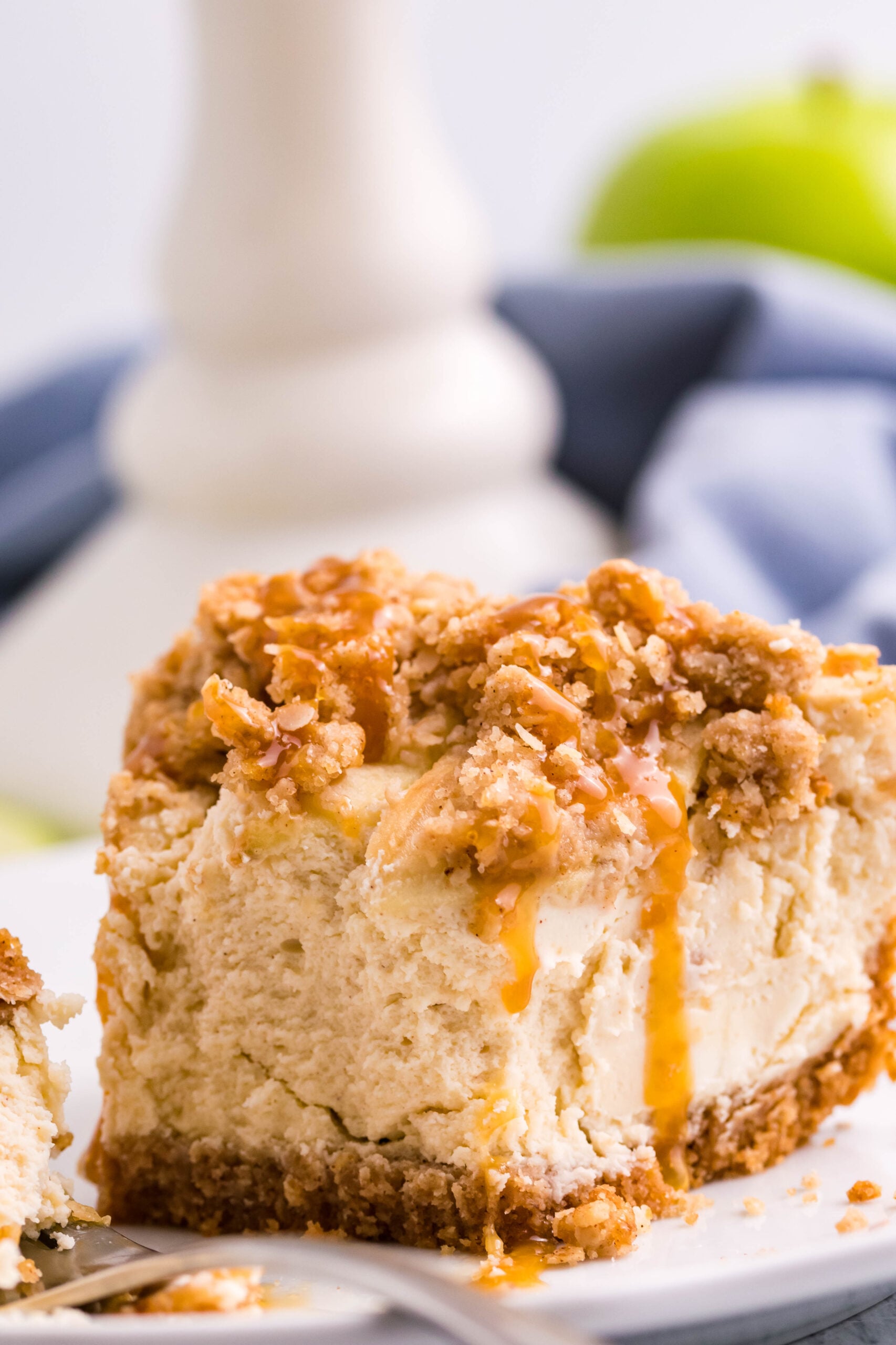 slice of Caramel Apple Crisp Cheesecake with a bite missing