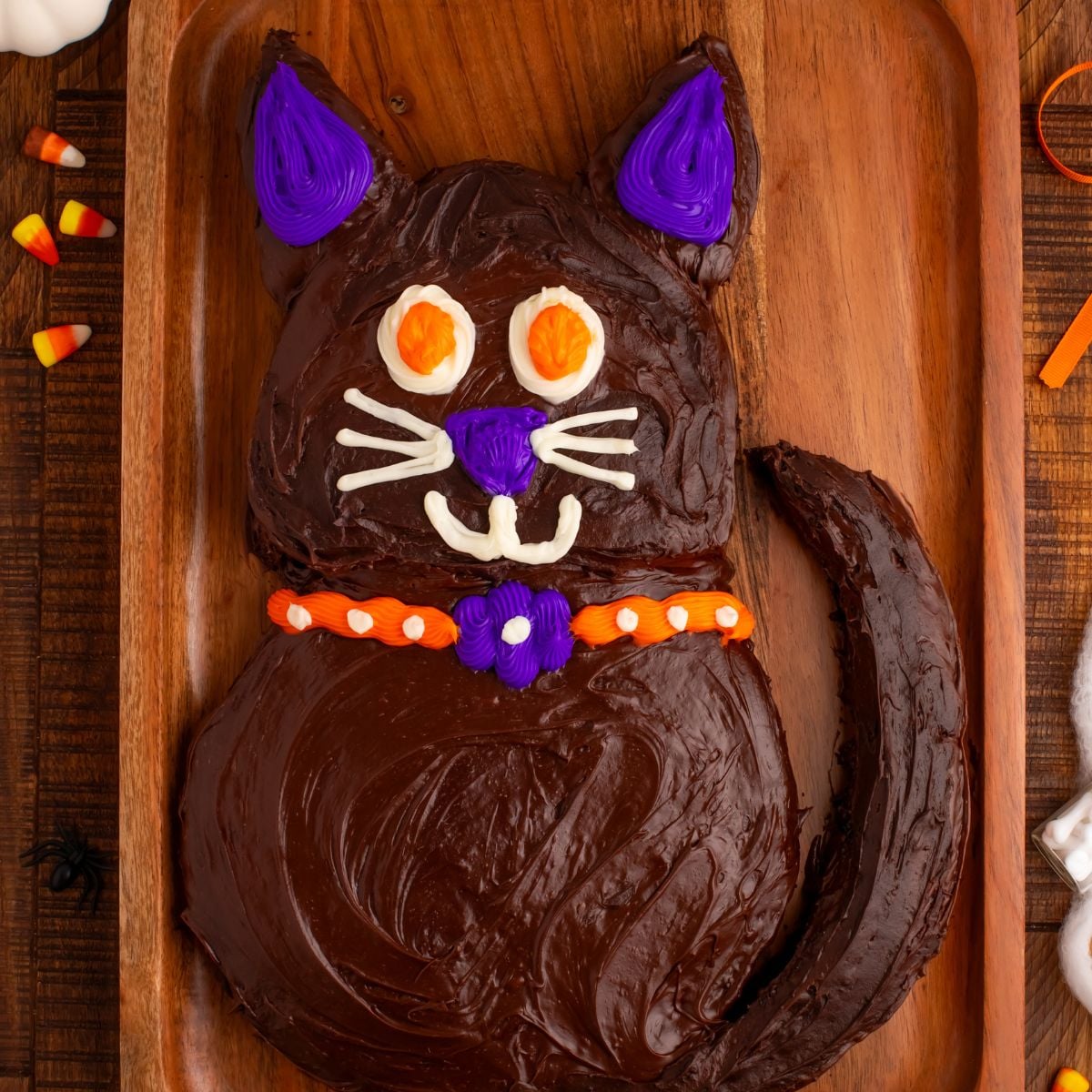 Halloween Black Cat Cut Out Cake on serving tray sitting on table 