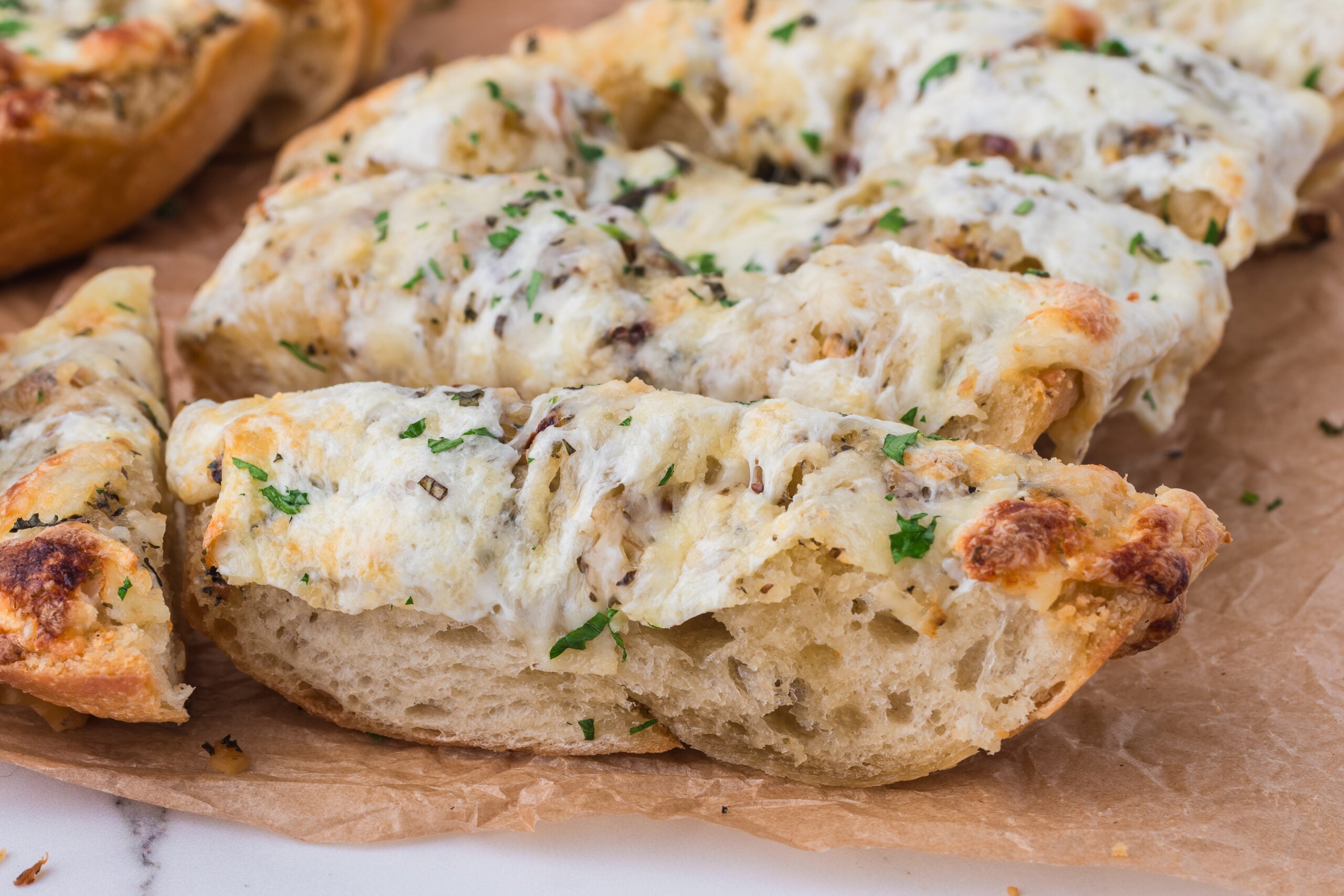 Cheesy Garlic Bread sliced and placed on table
