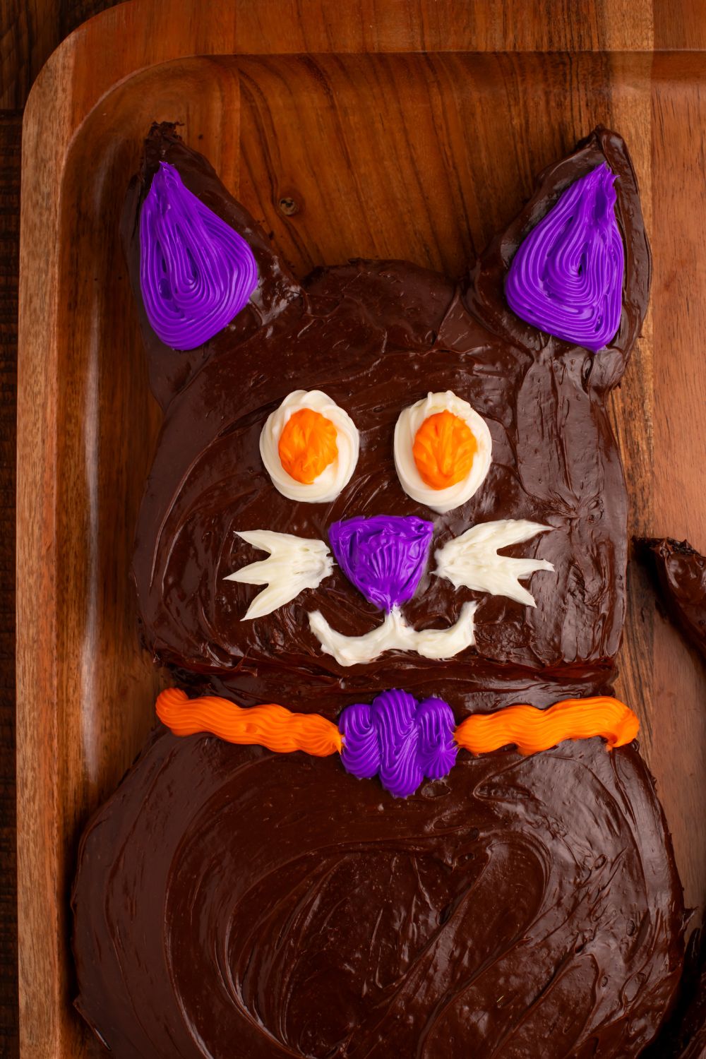 close up of Halloween cat cake on a wooden tray 