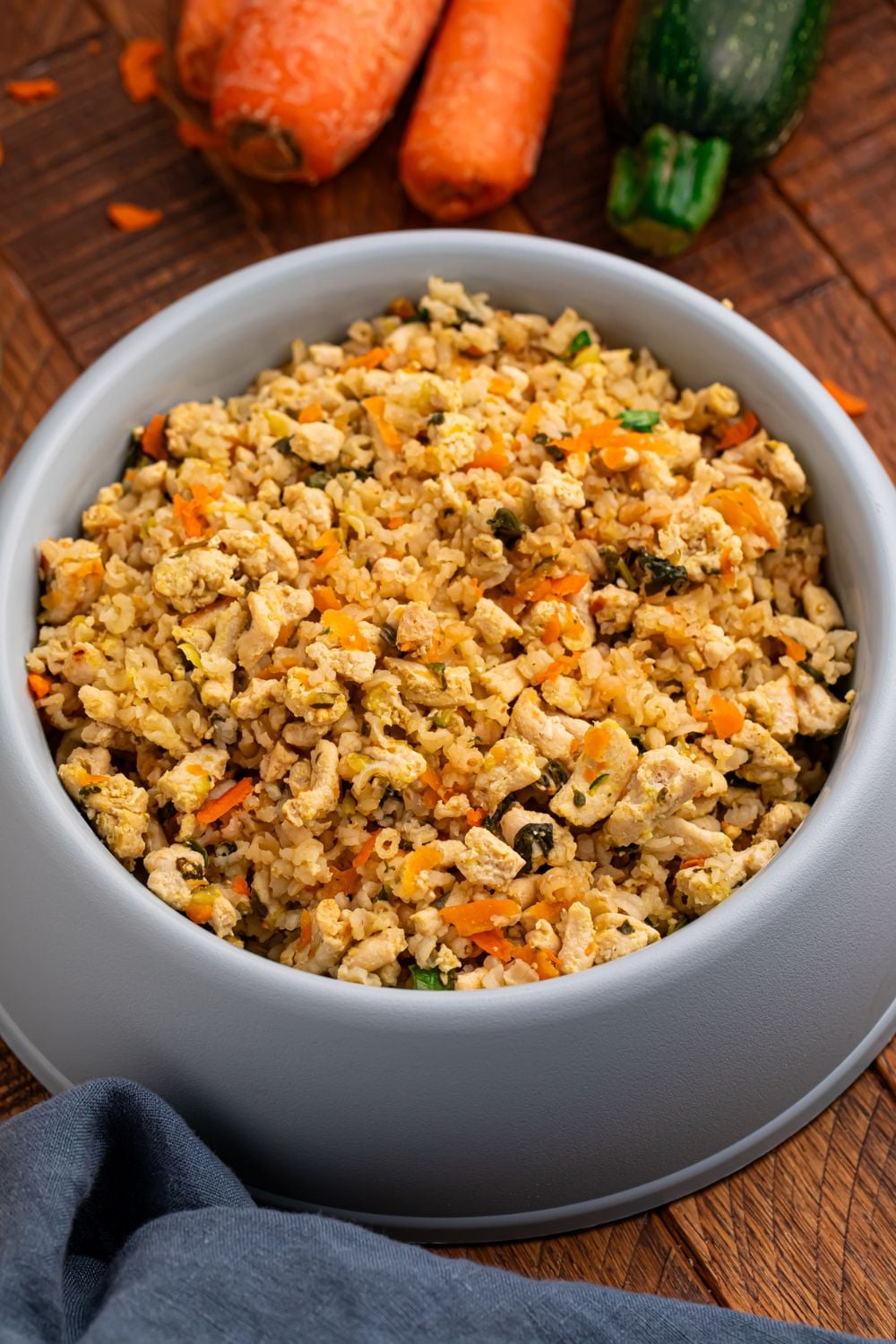 overhead look of homemade dog food in a grey bowl on table 
