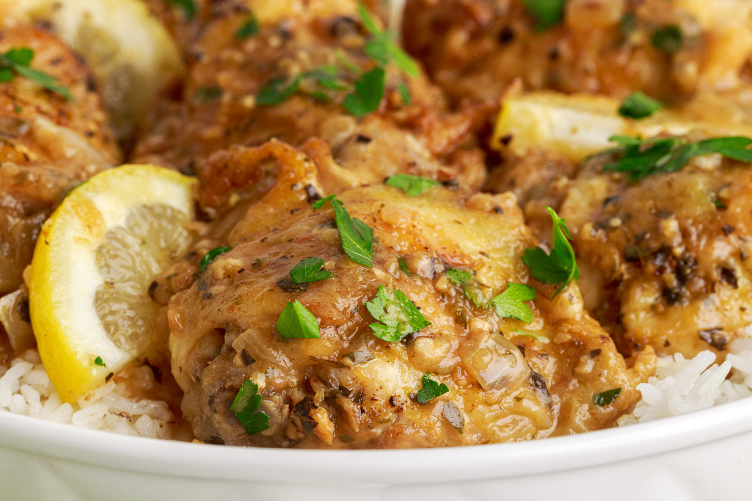 close up shot of the Instant Pot Lemon Butter Chicken in a white serving dish sitting on a table