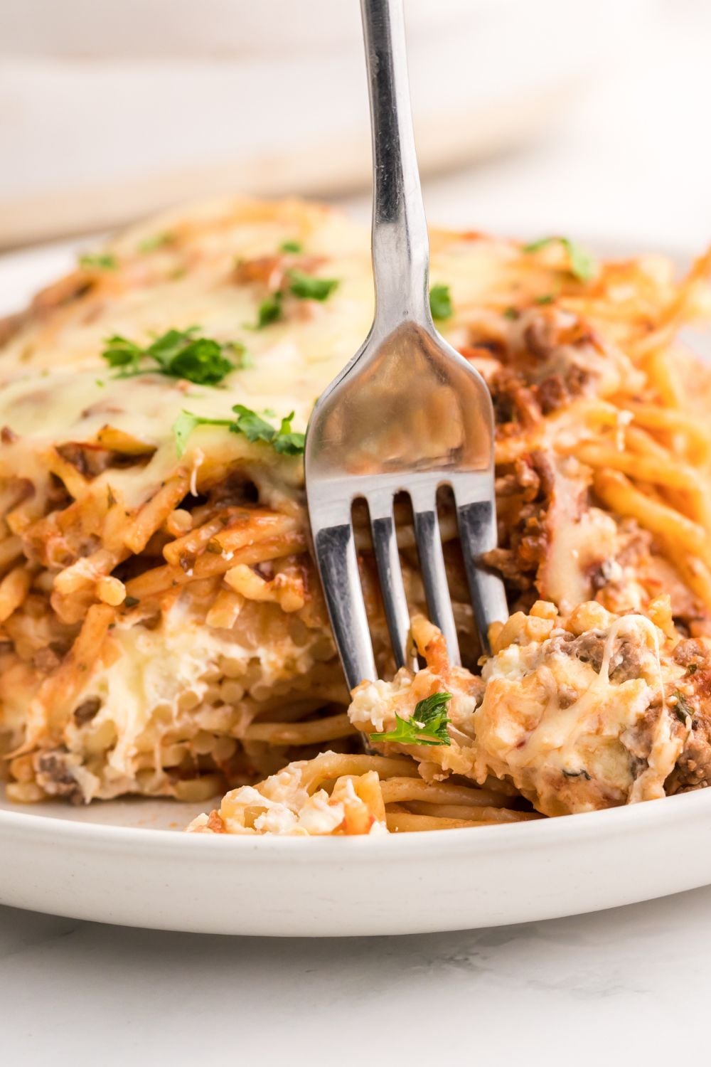 Million Dollar Spaghetti Casserole on a plate with a fork in it