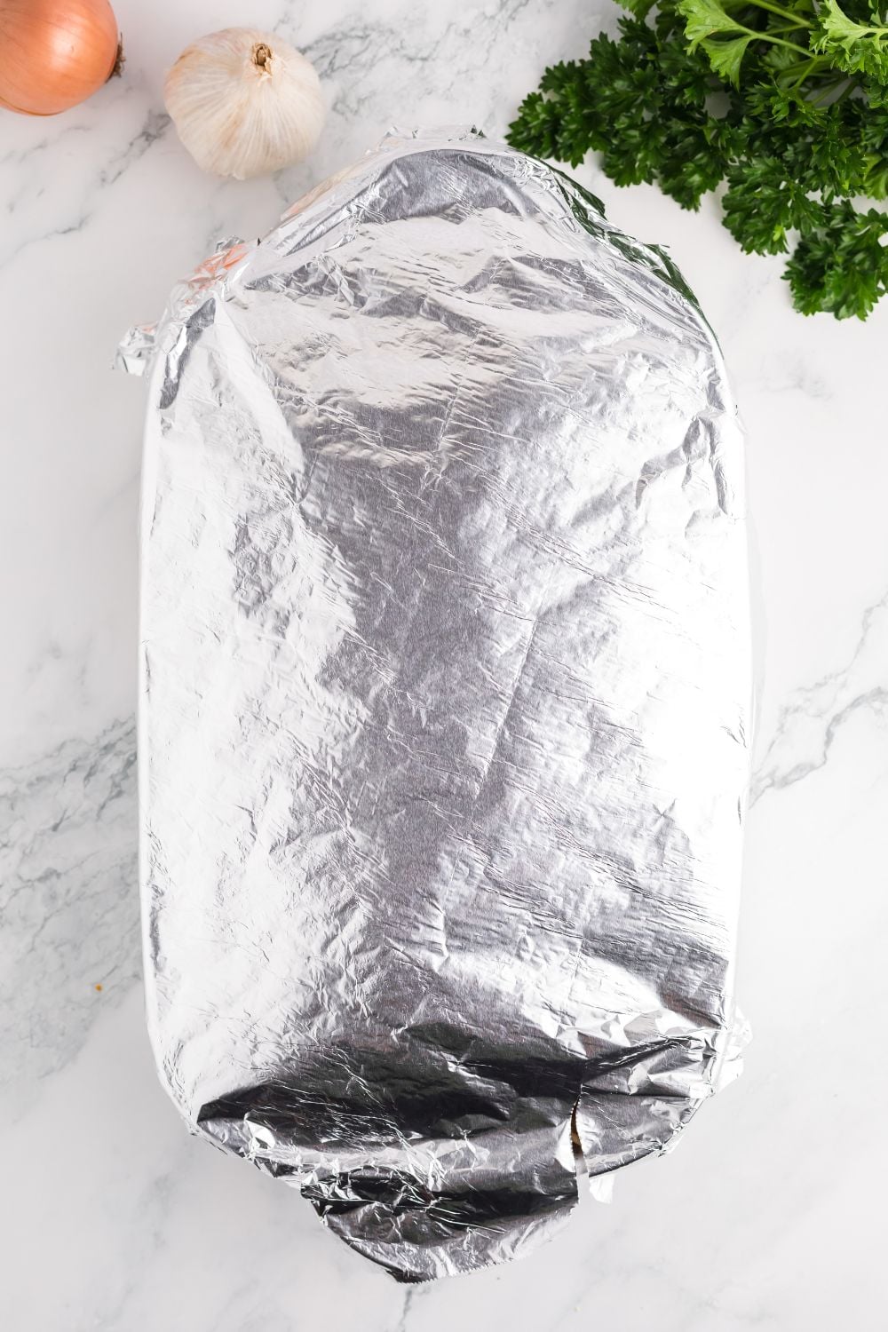 foil covered casserole dish on table