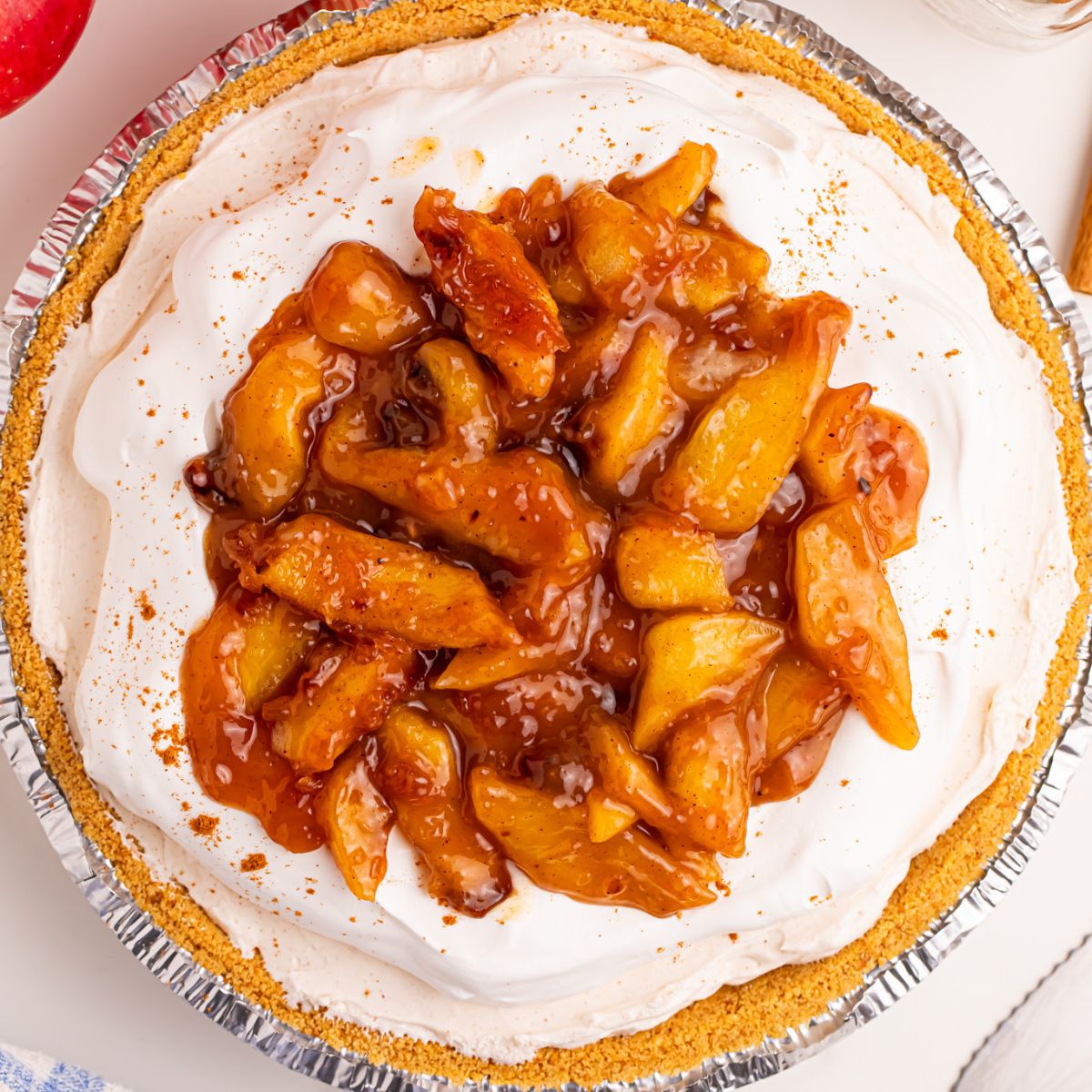 No Bake Apple Cheesecake pie on table in pie pan