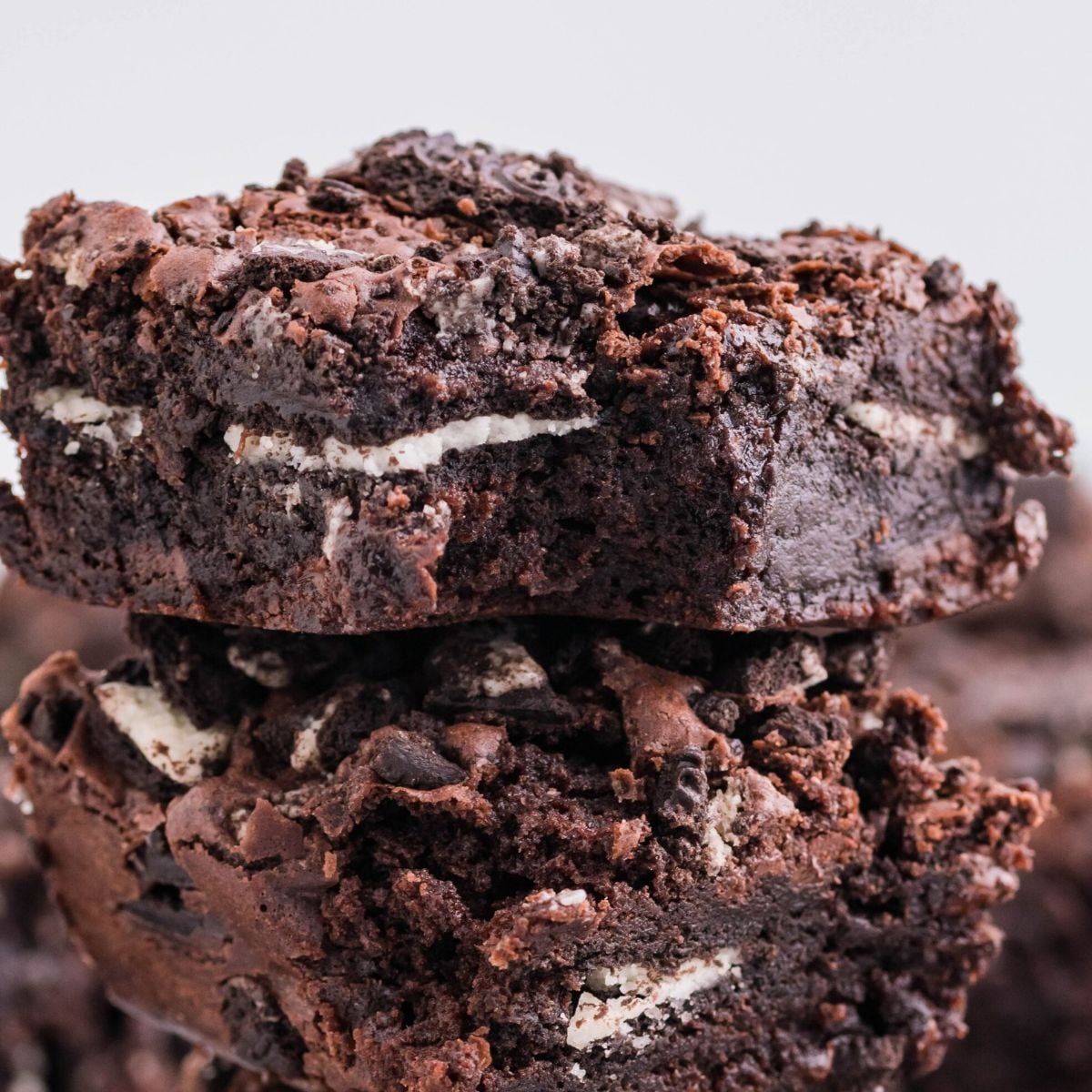 Oreo Stuffed Brownies stacked on top of one another on table