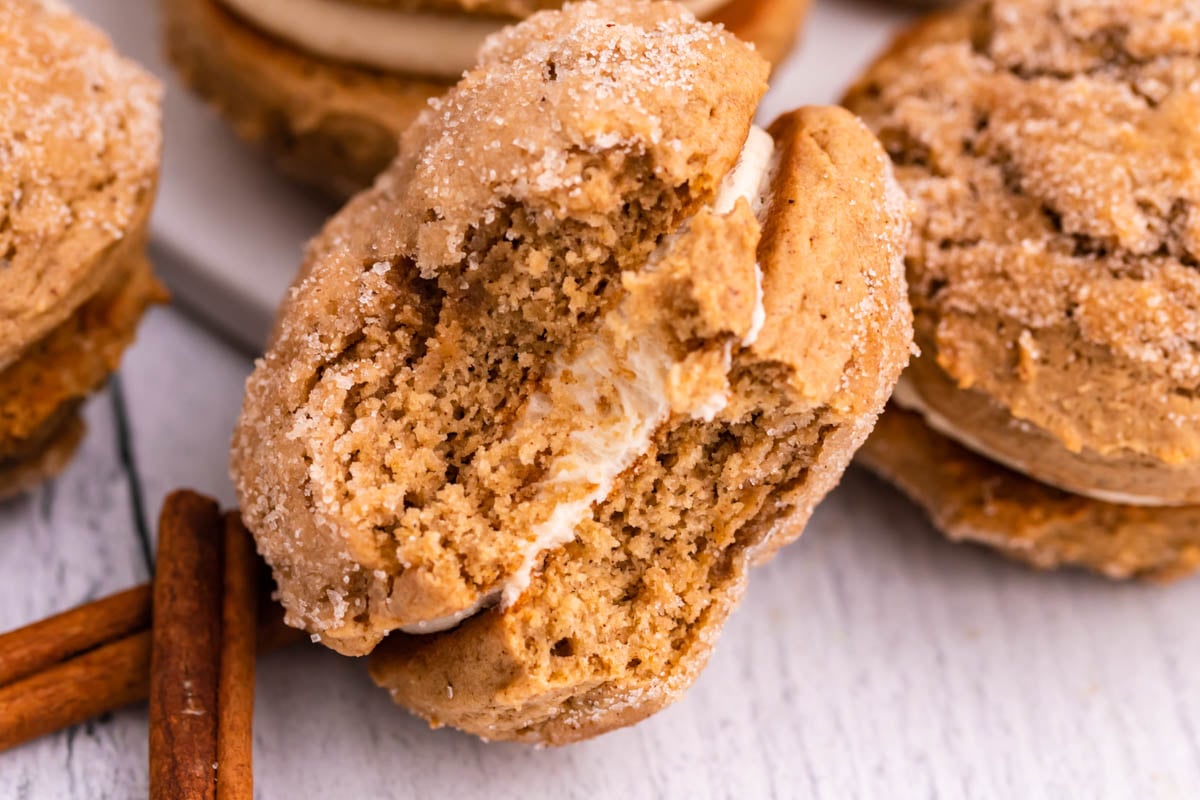 Apple Cider Whoopie Pie with a bite missing showing the inside filling