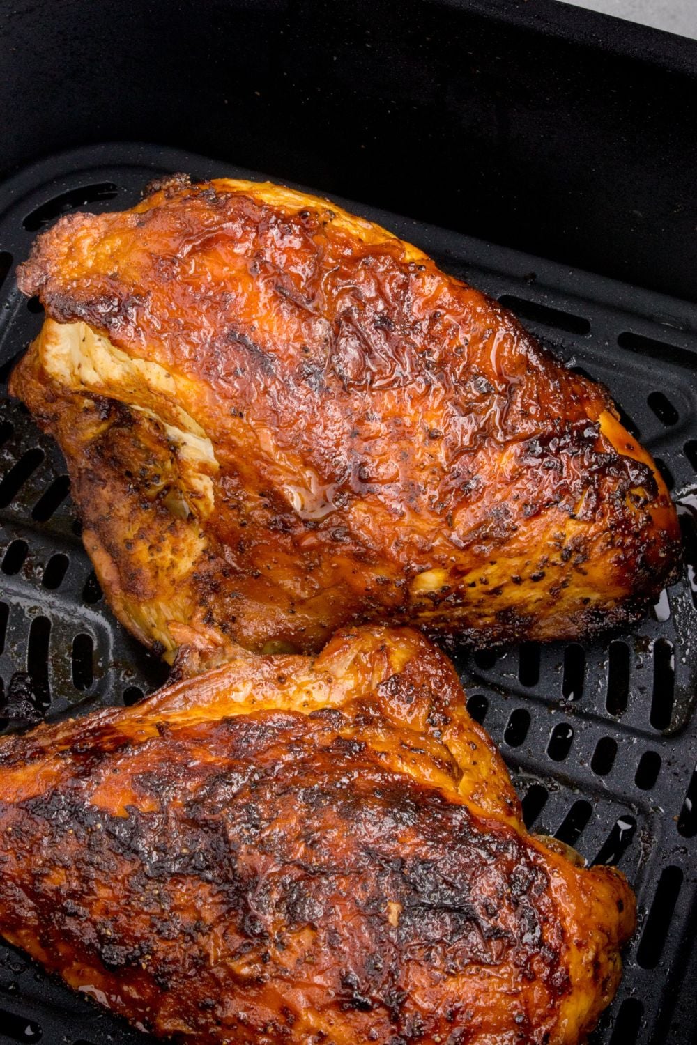 Air Fryer Chicken Breast basket with cooked chicken inside