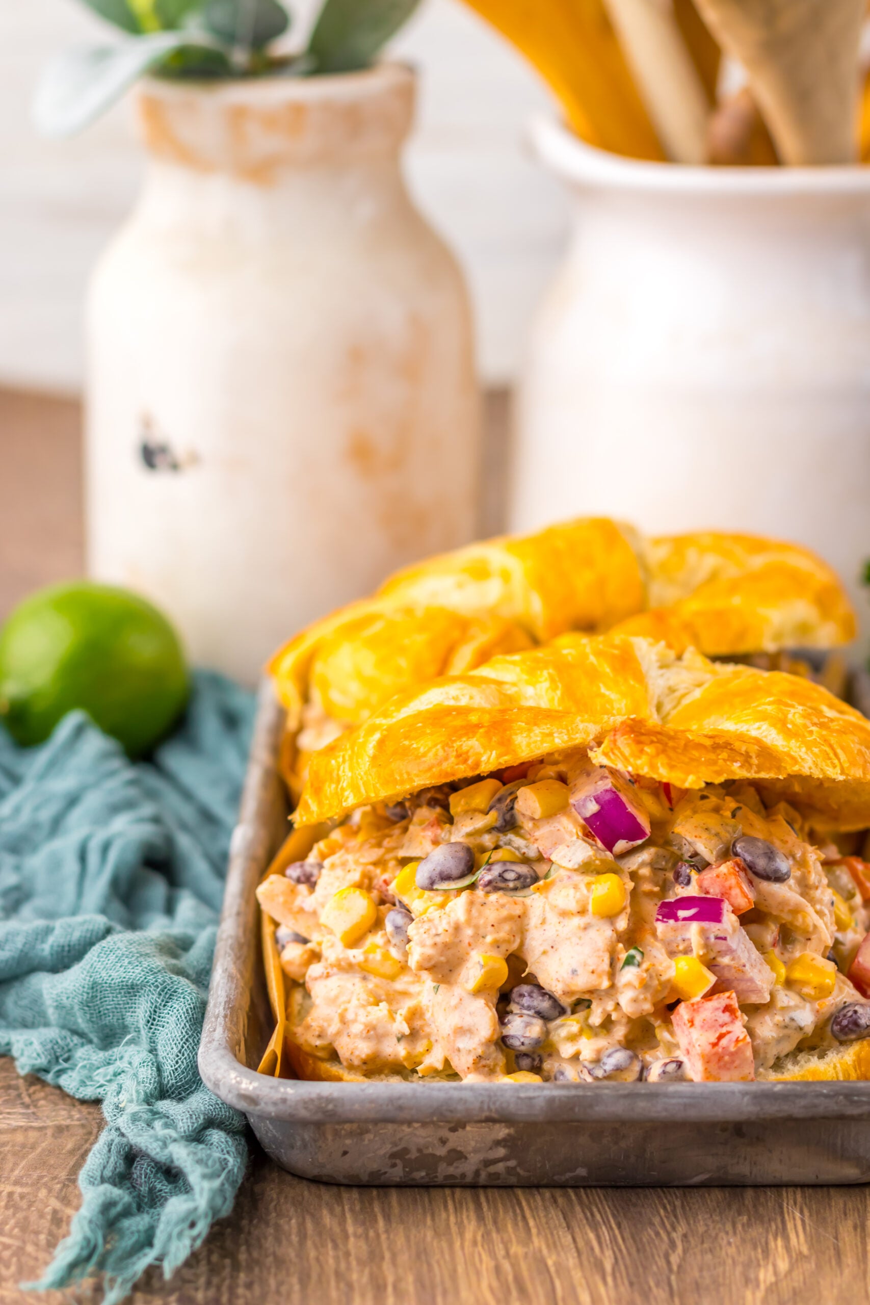 Creamy Taco Chicken Salad in a croissant in a silver serving platter