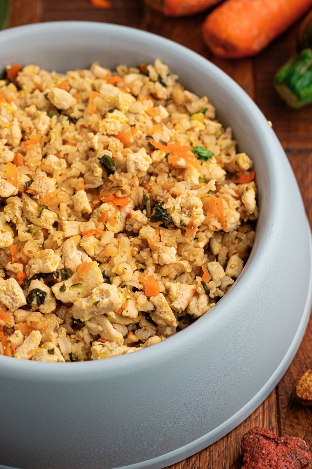 side view of a dog bowl full of Homemade Turkey and Rice Dog Food with Veggies