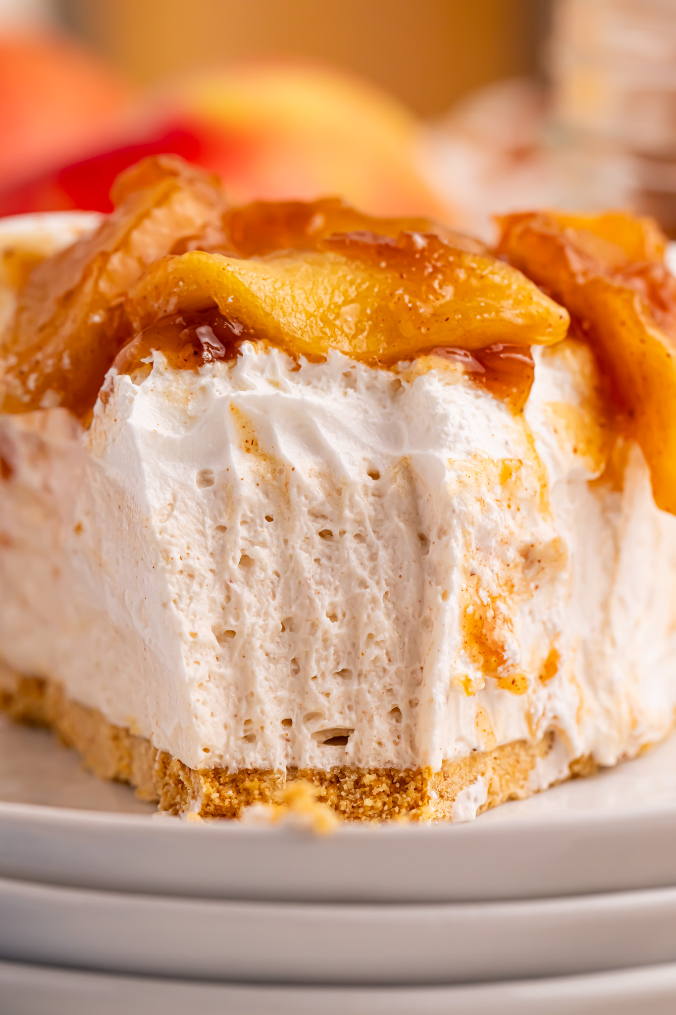No Bake Apple Cheesecake pie slice up close with a big bite missing