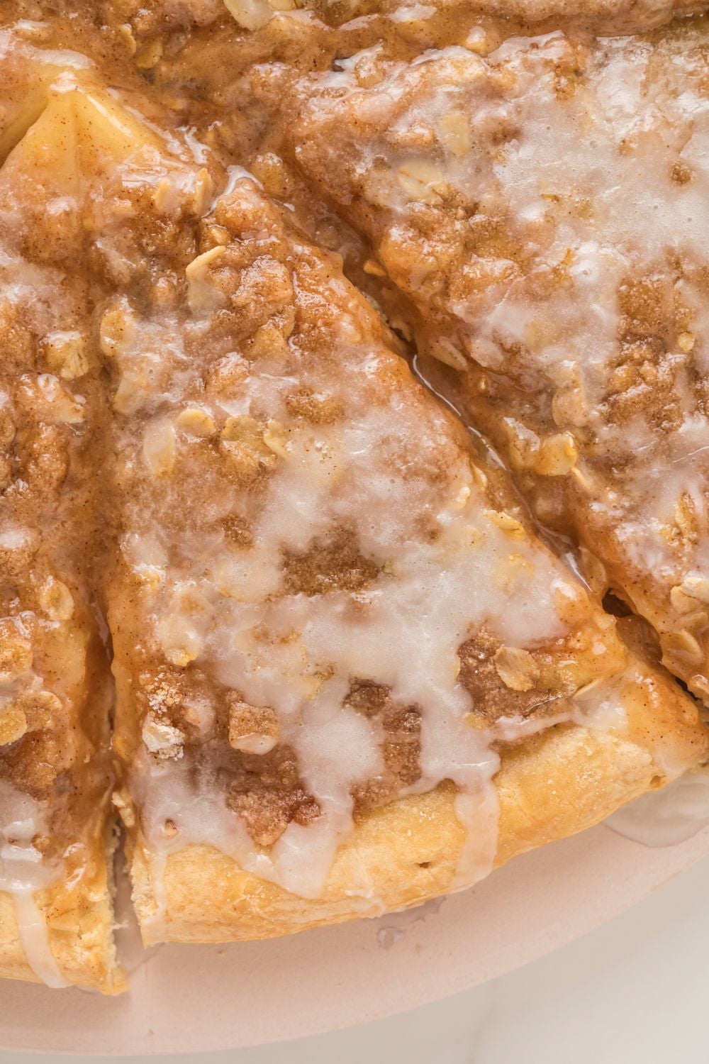 Apple Pie Pizza sliced on table with a close up of the slices