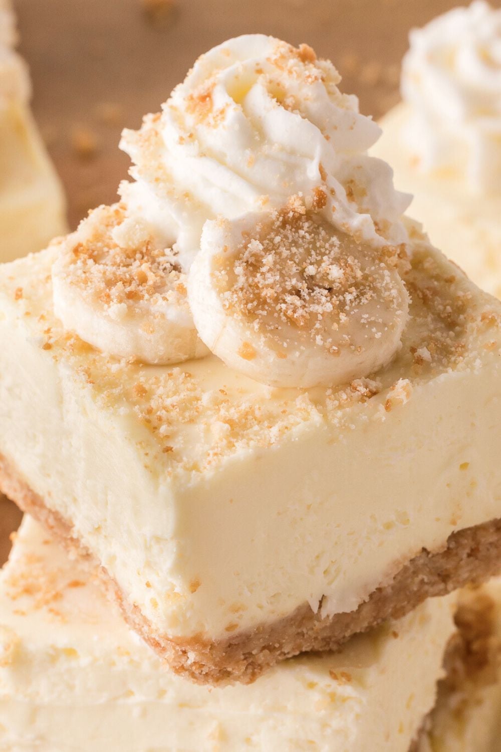 close up of No Bake Banana Pudding Cheesecake Bars stacked on a plate