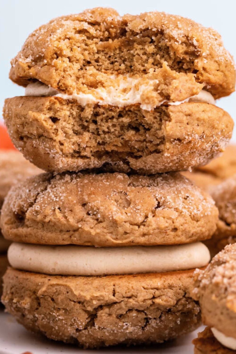 stack of Apple Cider Whoopie Pies on table with the top one with a bite taken out of it