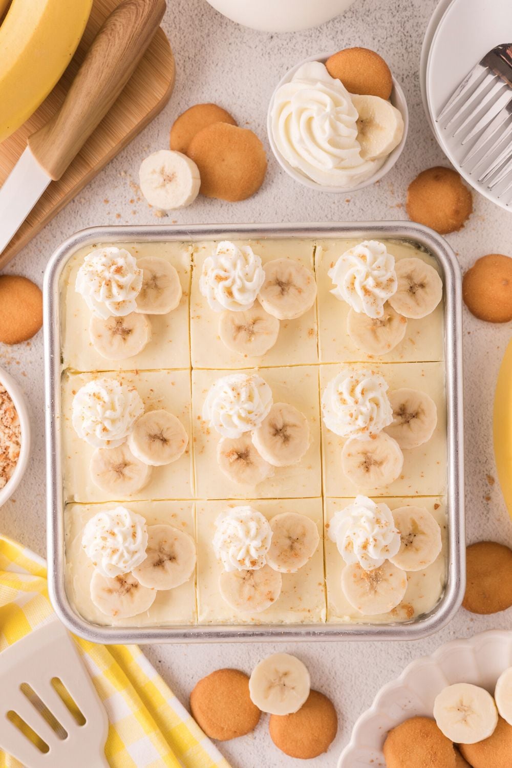 assembled and decorated No Bake Banana Pudding Cheesecake Bars in pan on table